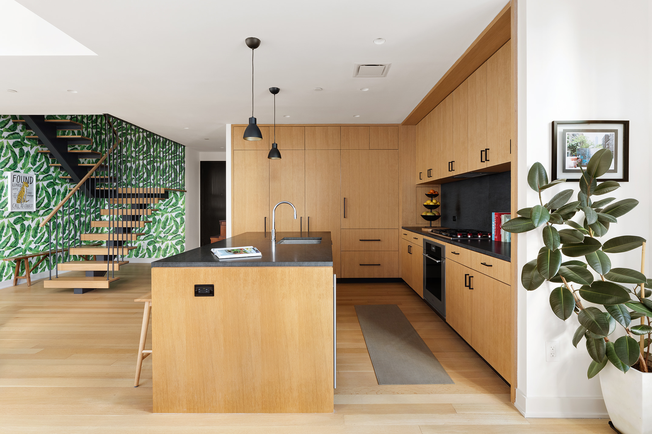 a kitchen with stainless steel appliances a stove a sink and a refrigerator