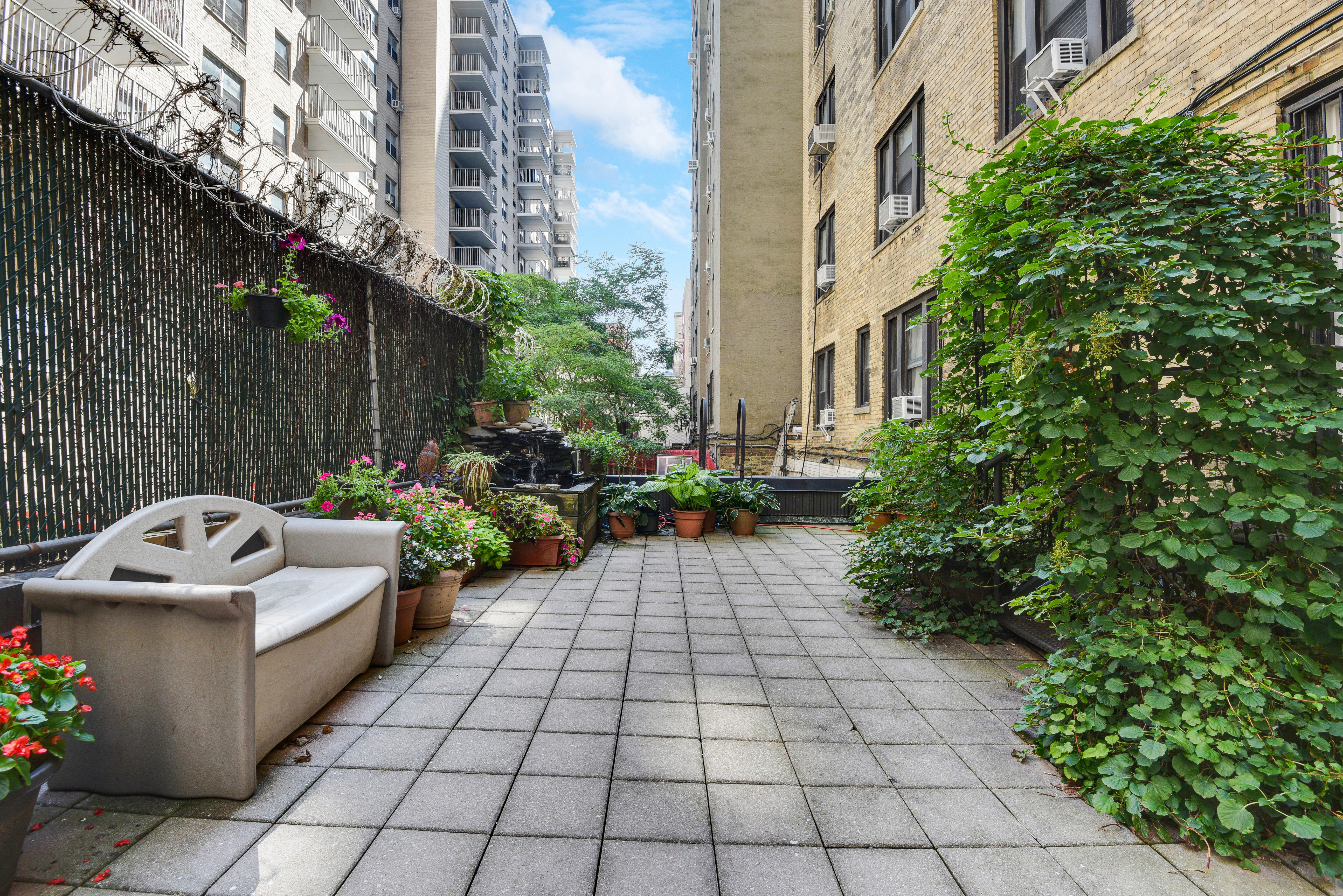 a view of a yard with chairs in a patio