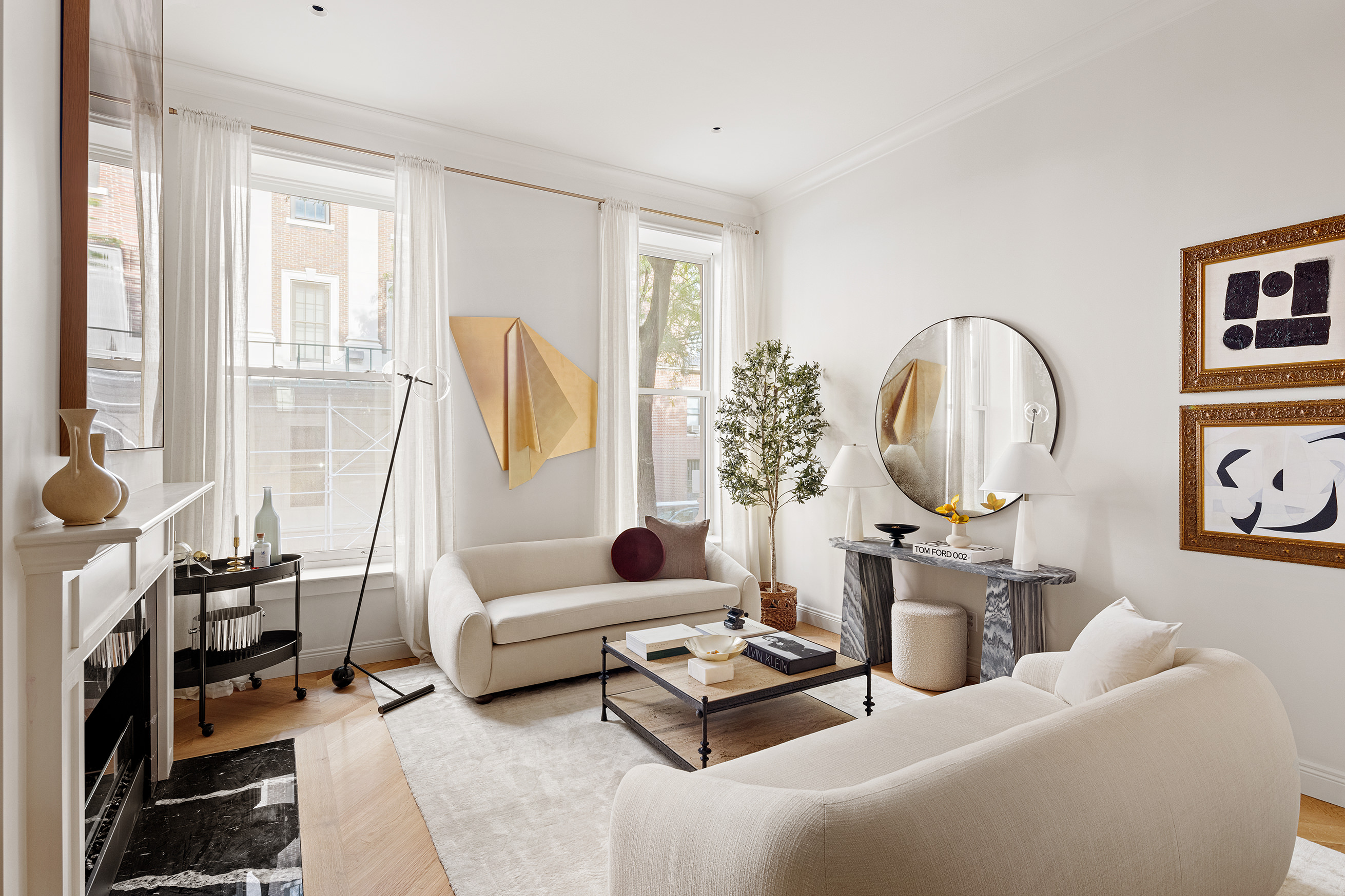 a living room with furniture a fireplace and a potted plant