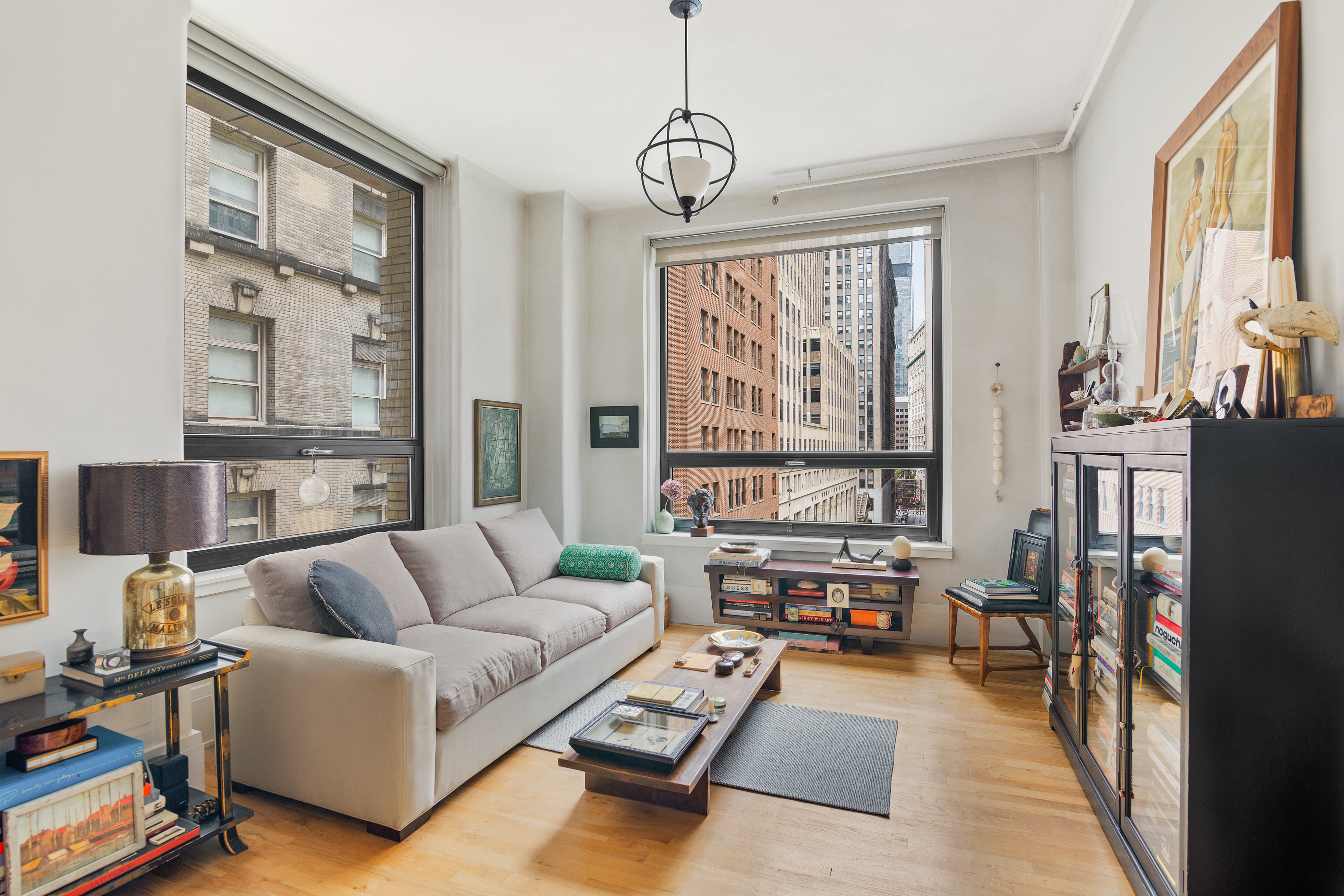 a living room with furniture and large windows