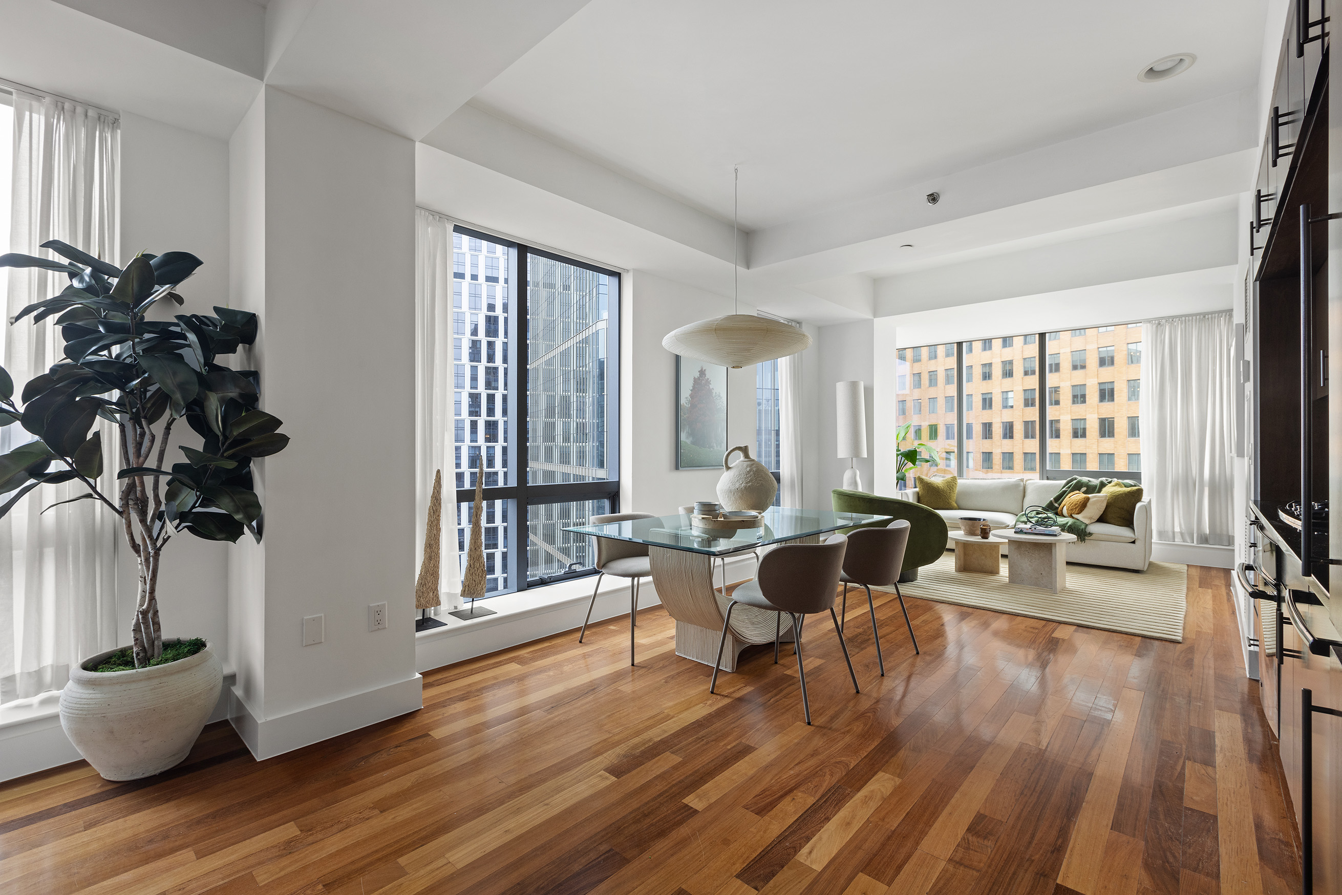 a living room with furniture and wooden floor