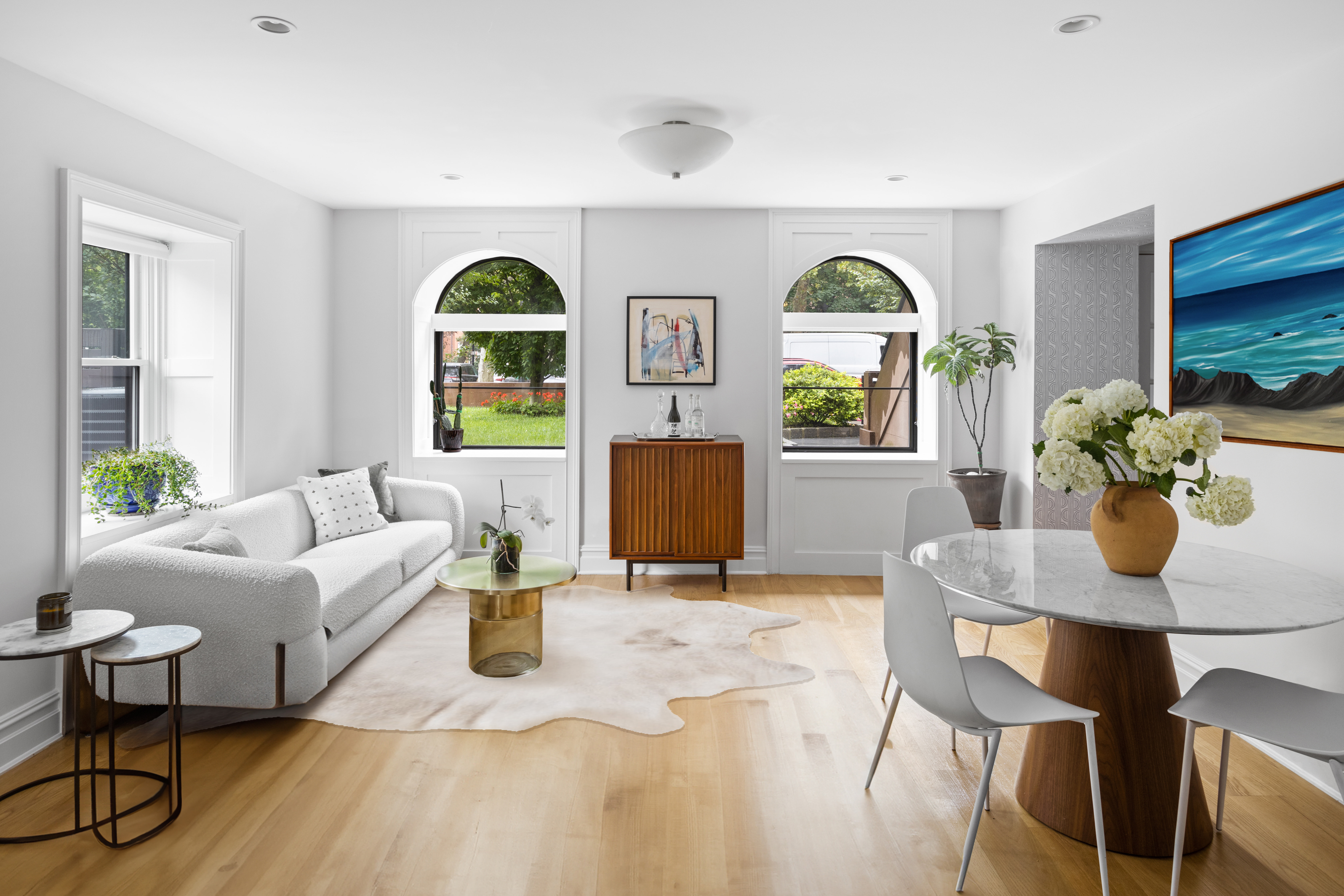 a living room with furniture a chandelier and a window