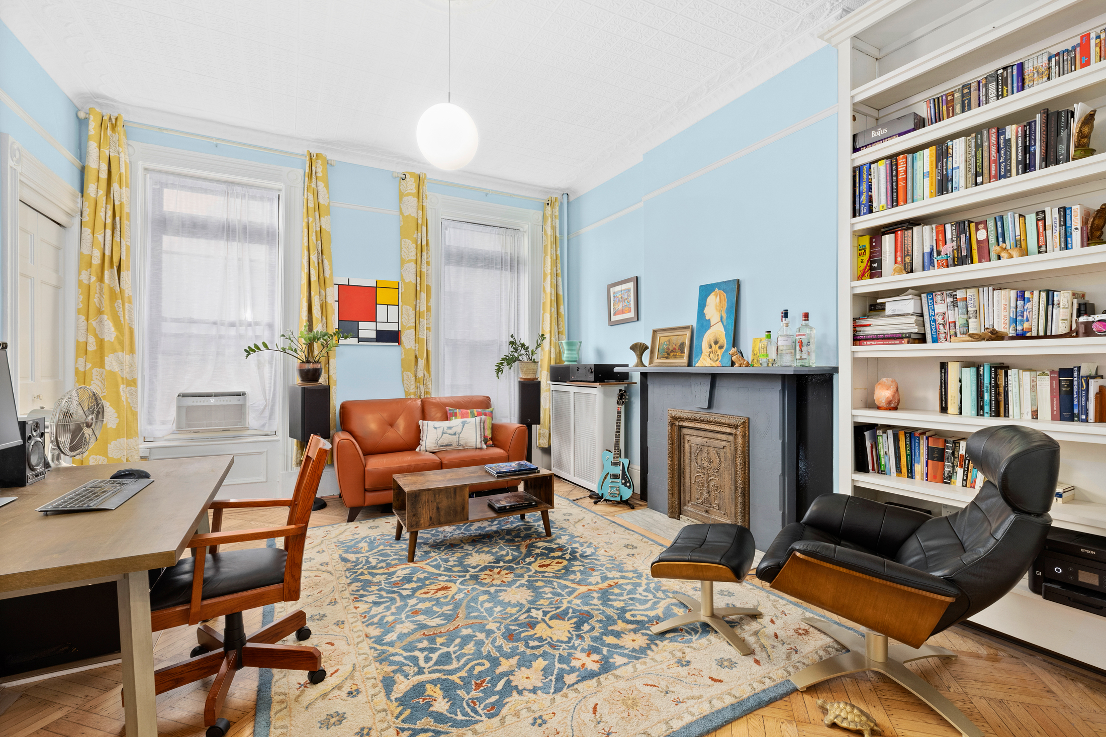 a living room with furniture and a book shelf