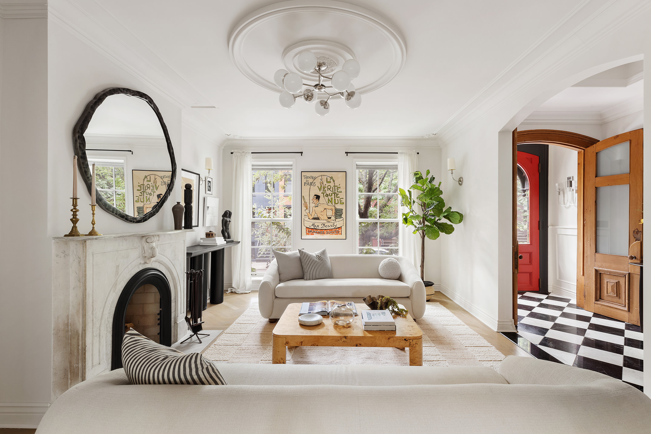 a living room with furniture a large window and a fireplace