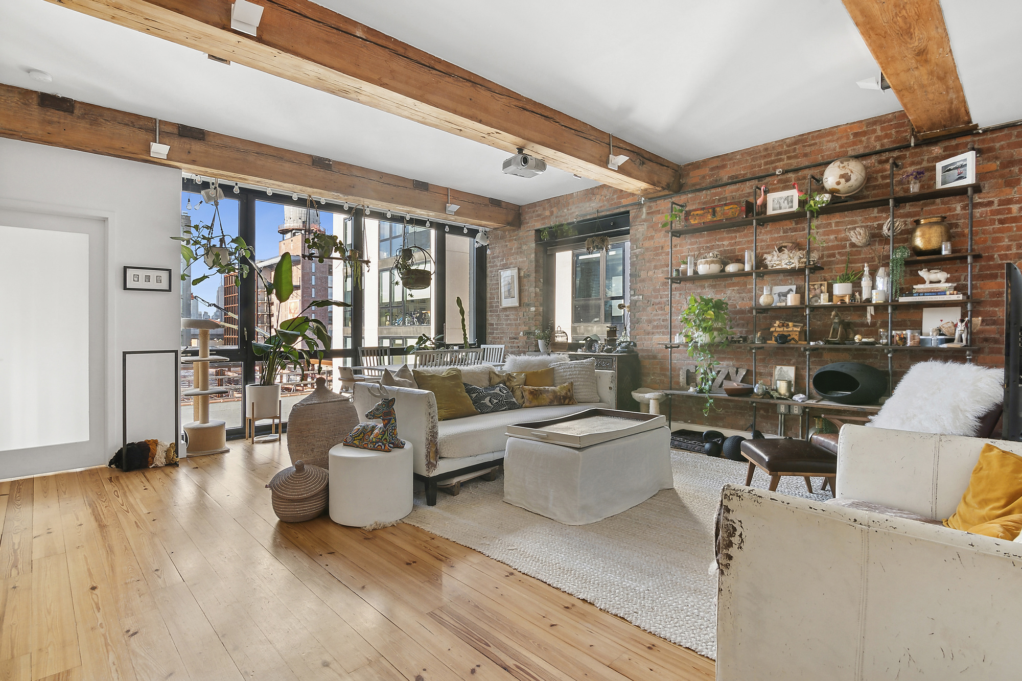 a living room with furniture and a floor to ceiling window