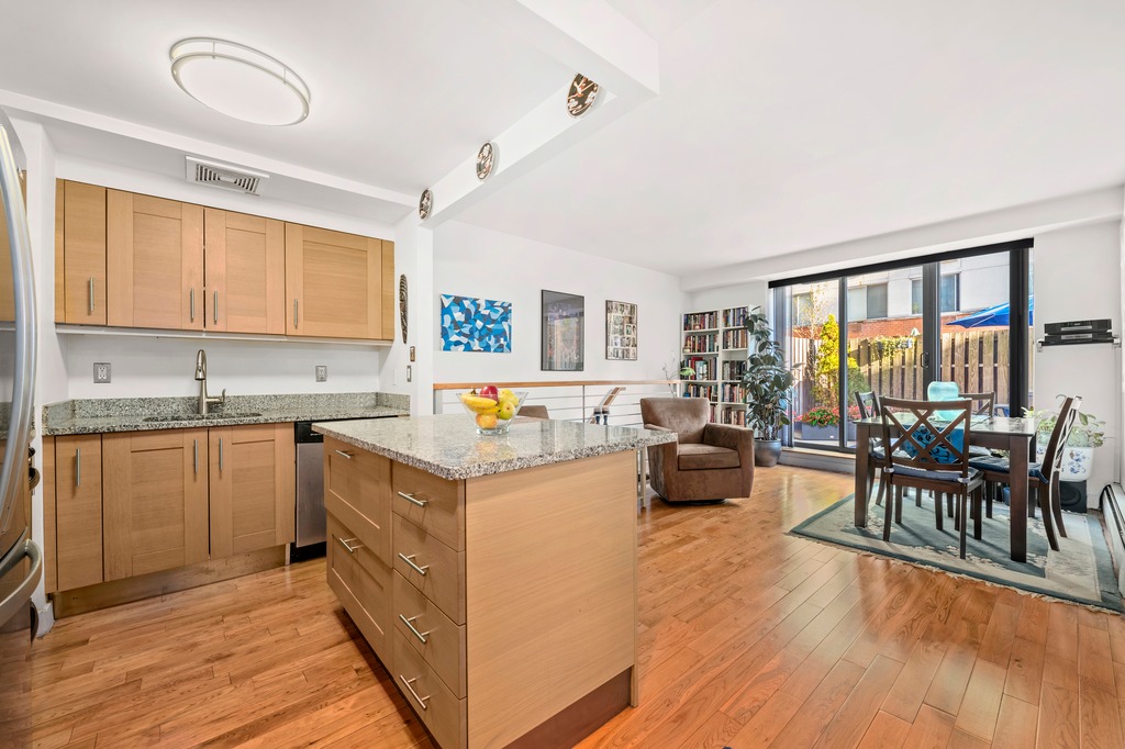 a kitchen with a table chairs stove and wooden floor