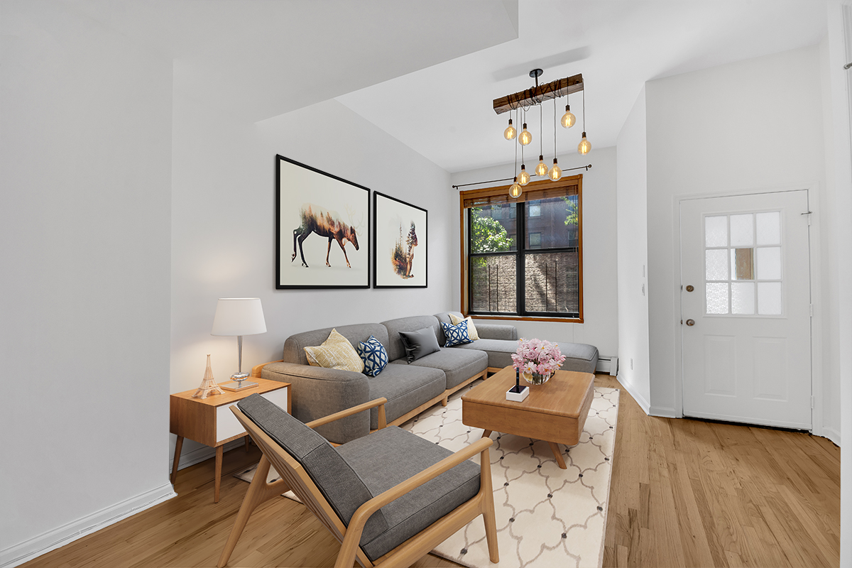 a living room with furniture a window and a table