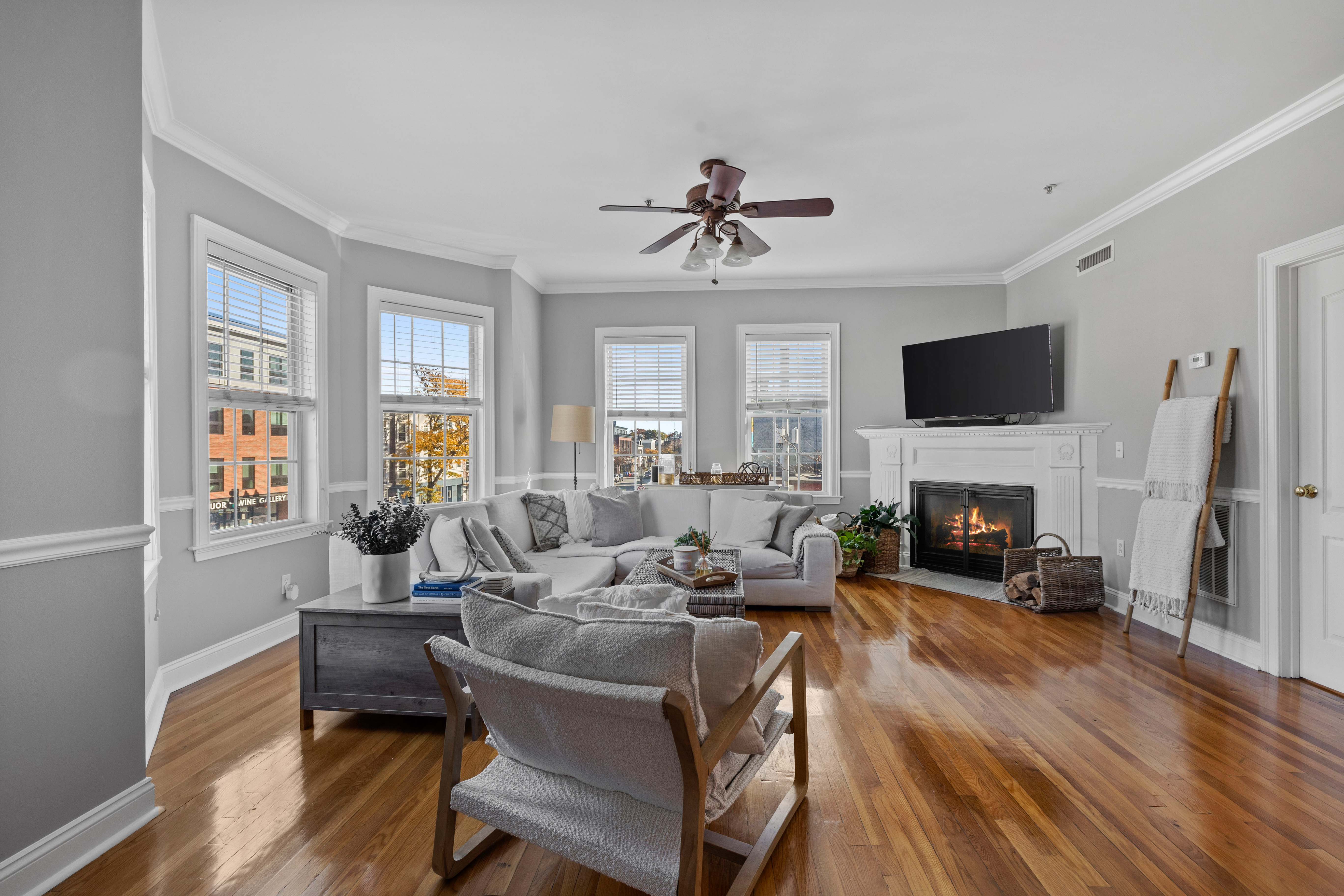 a living room with furniture a fireplace and a flat screen tv