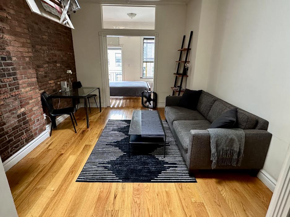 a living room with furniture and a rug