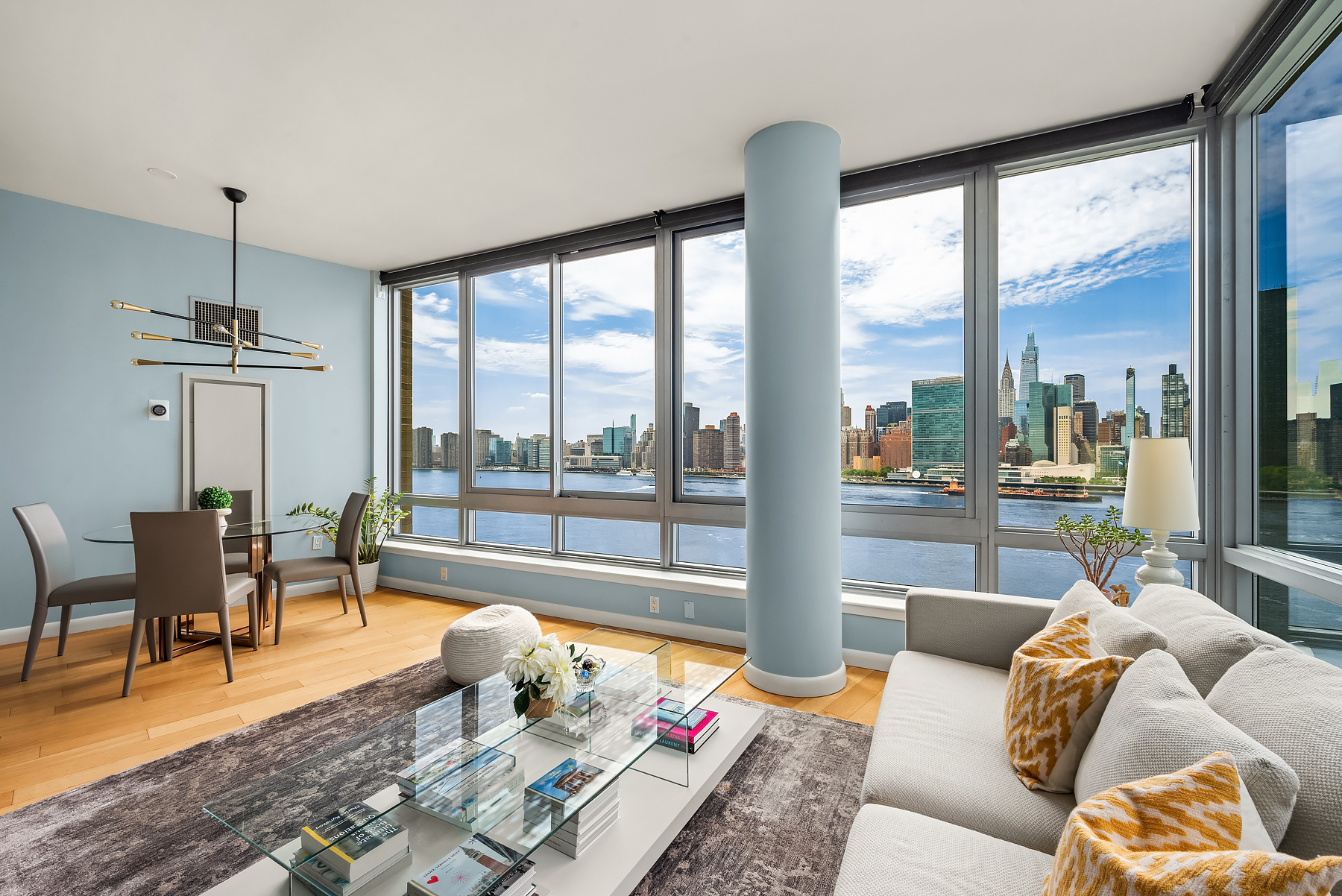 a living room with furniture and floor to ceiling windows