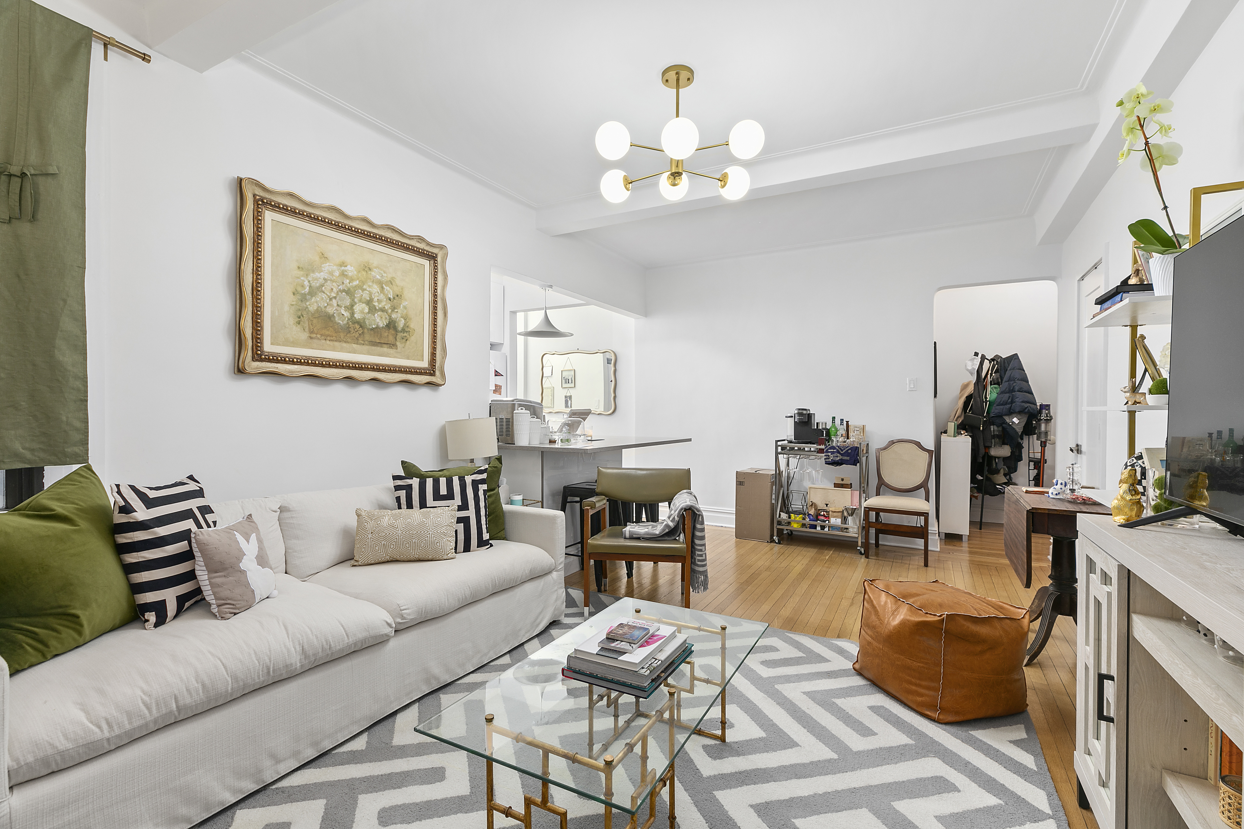 a living room with furniture and a chandelier