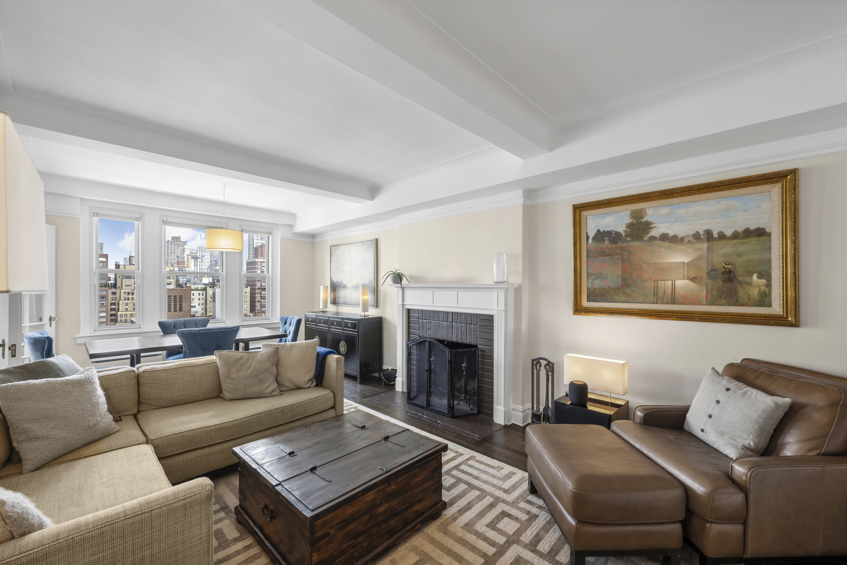 a living room with furniture a fireplace and a large window