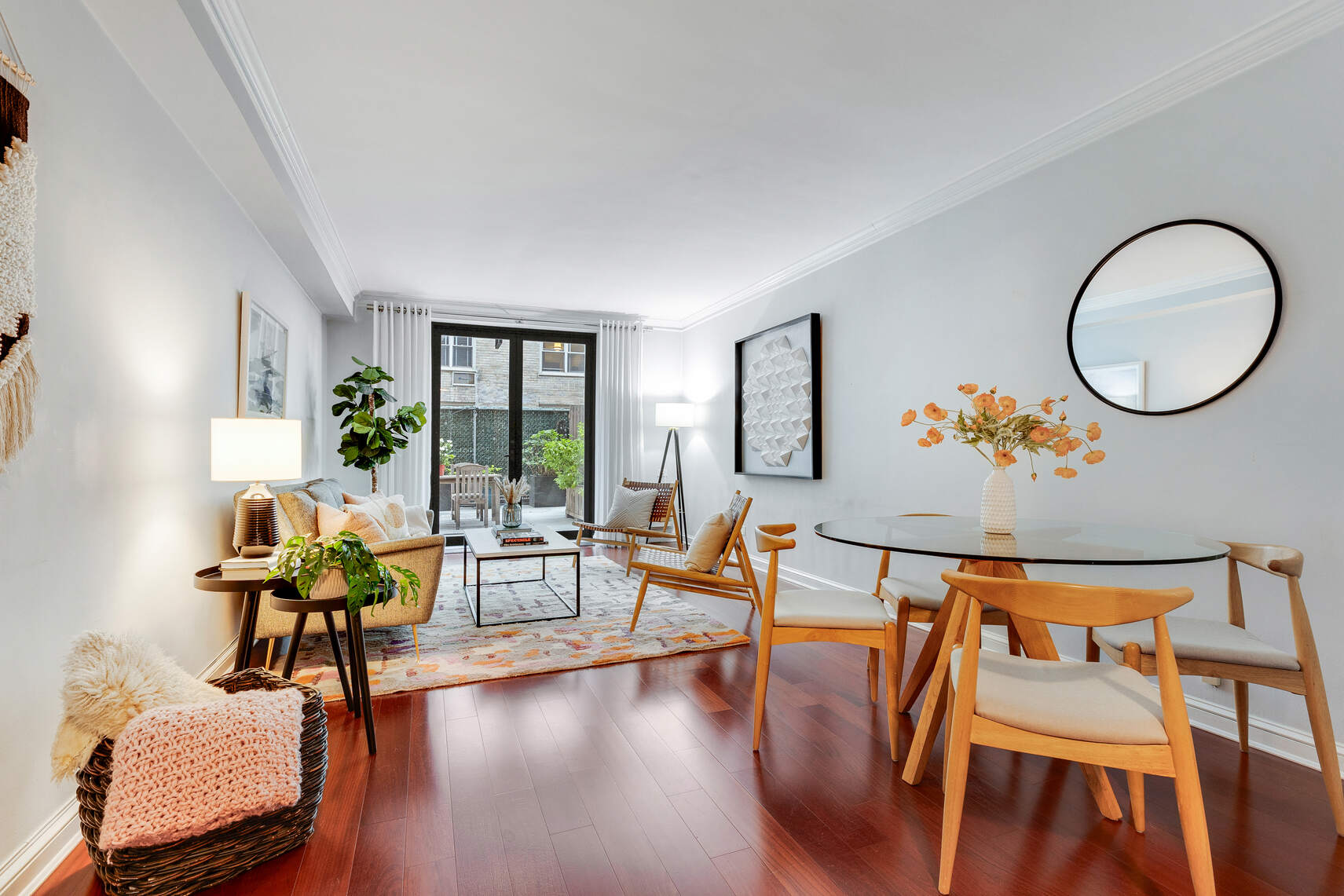 a living room with furniture and wooden floor