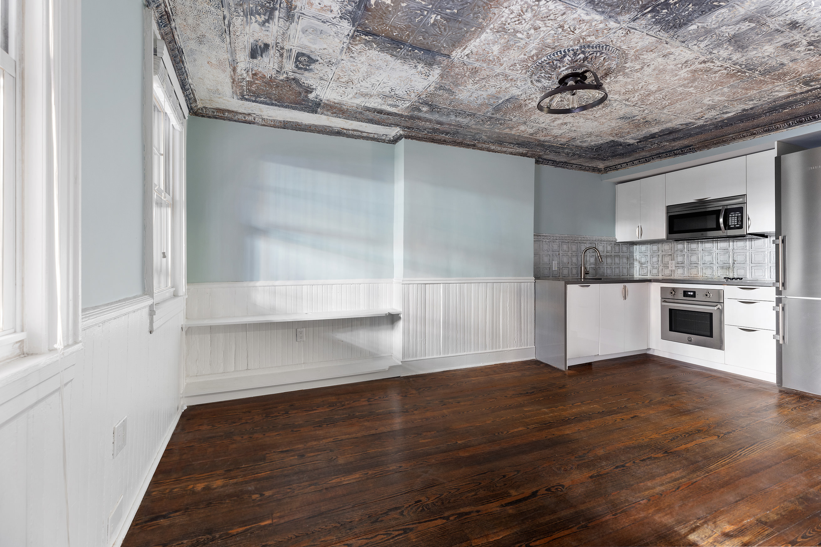 a view of a kitchen with a sink and microwave