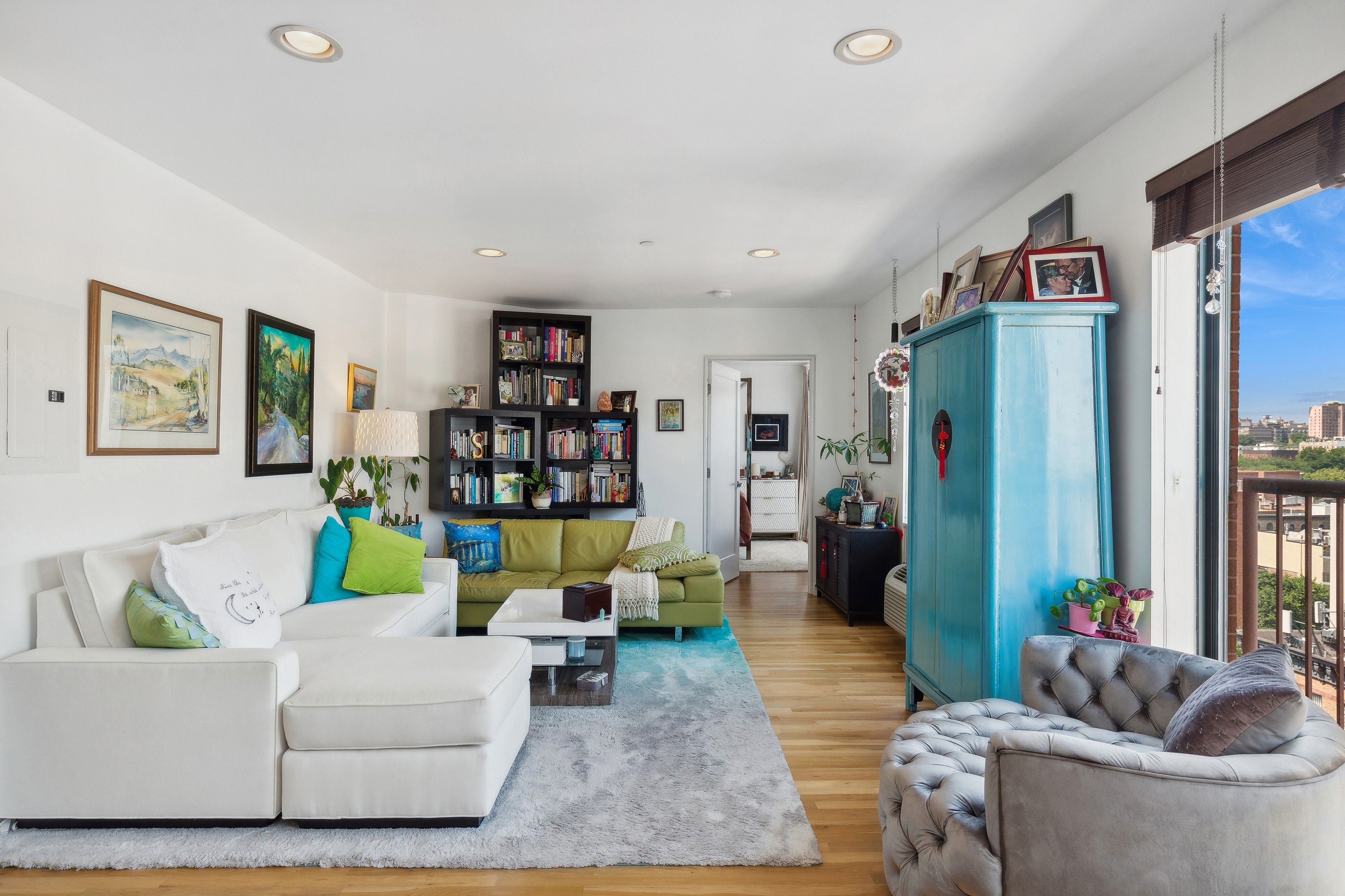 a living room with furniture and a wooden floor