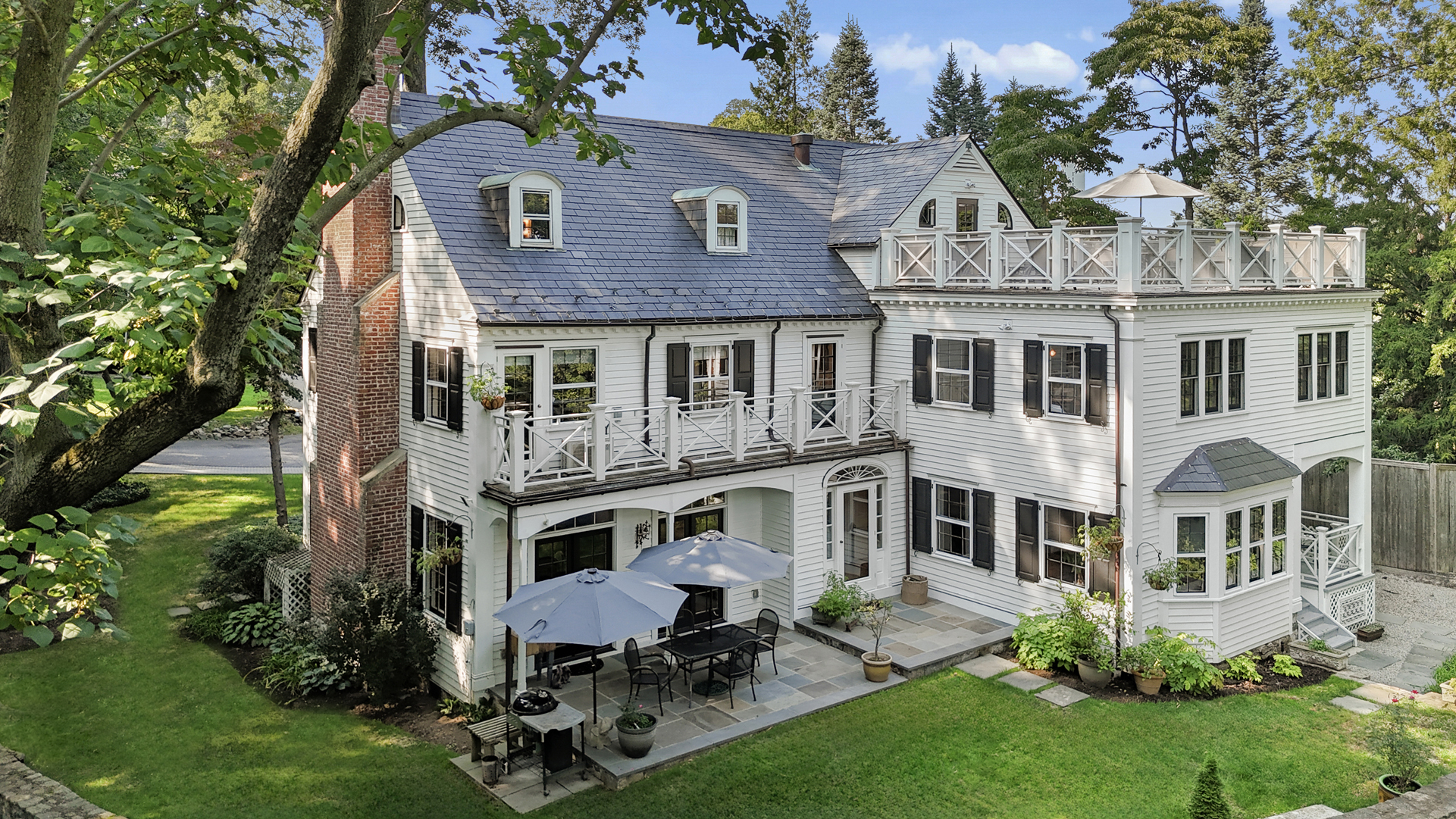 a aerial view of a house with a yard and sitting area