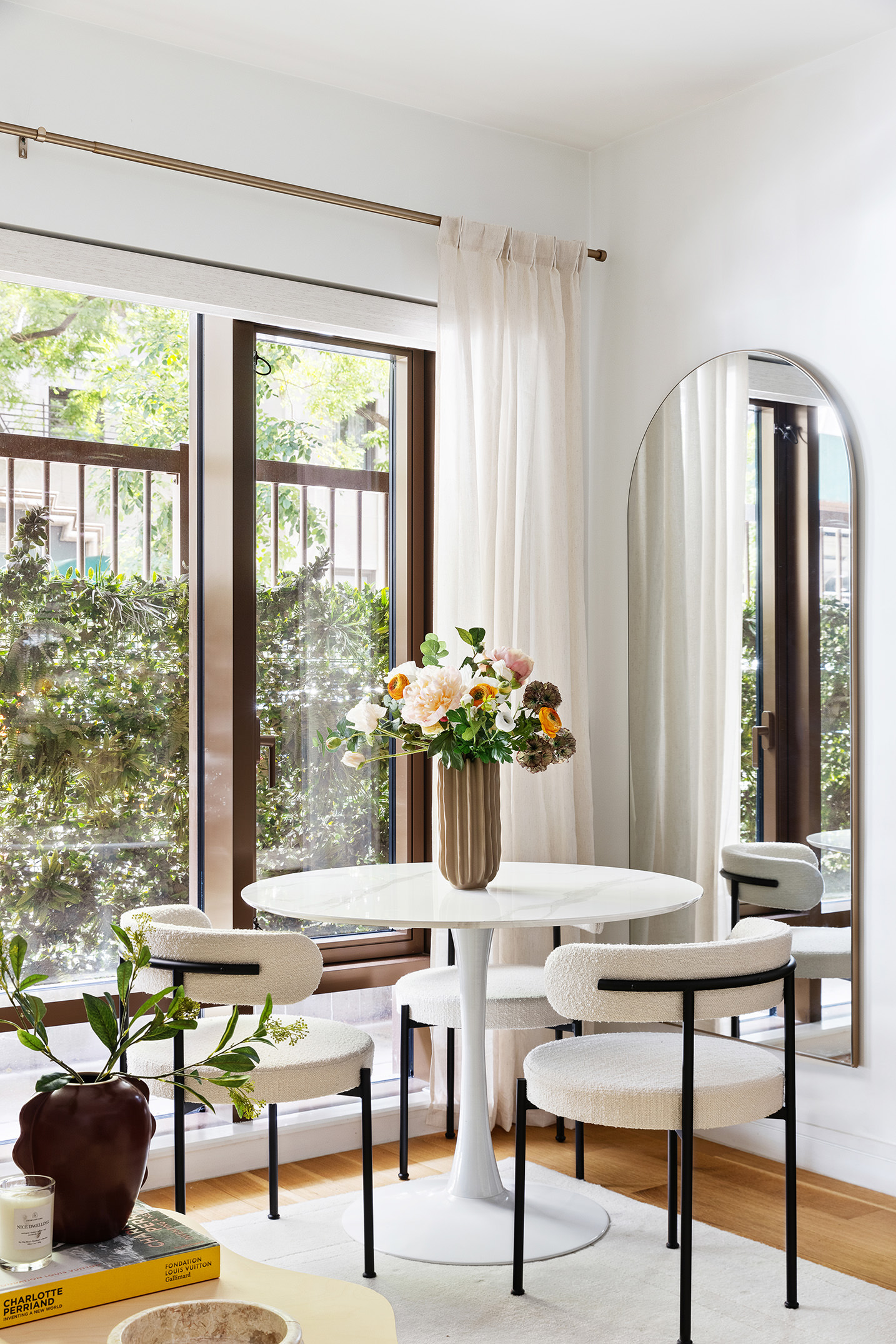 a living room with furniture and large windows