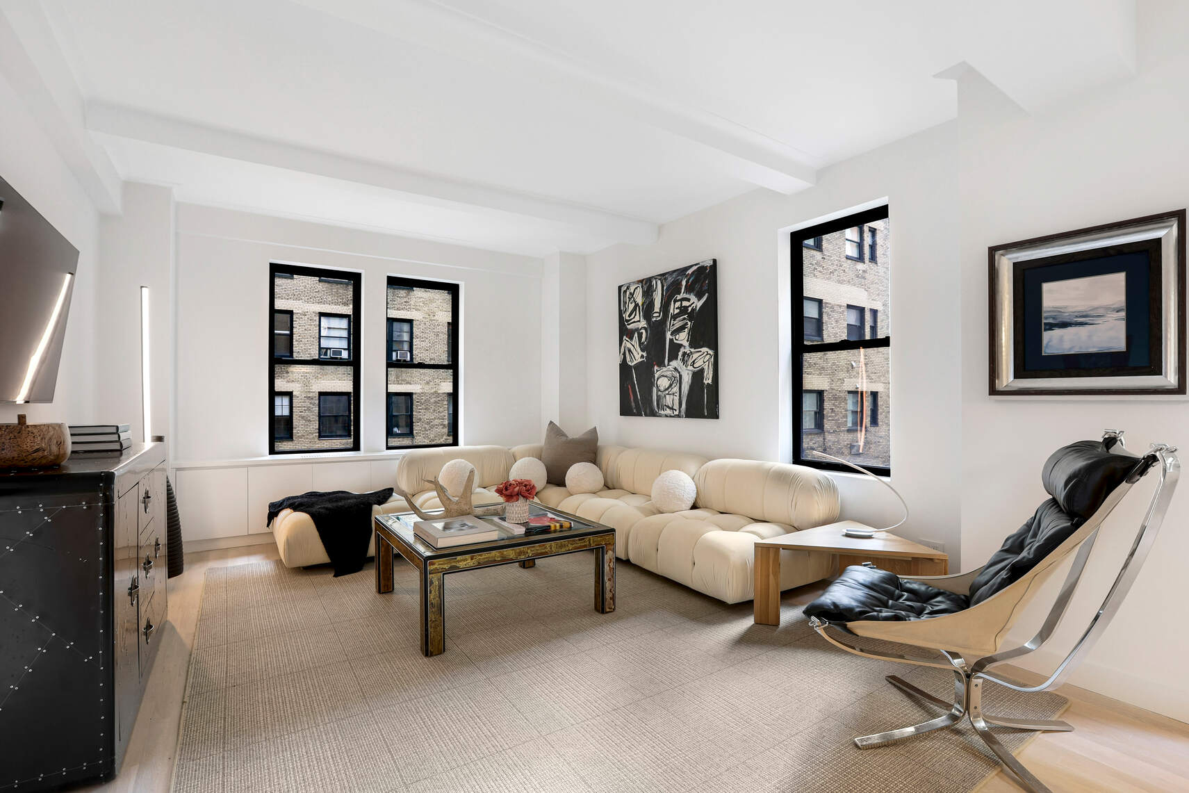 a living room with furniture a rug and a window