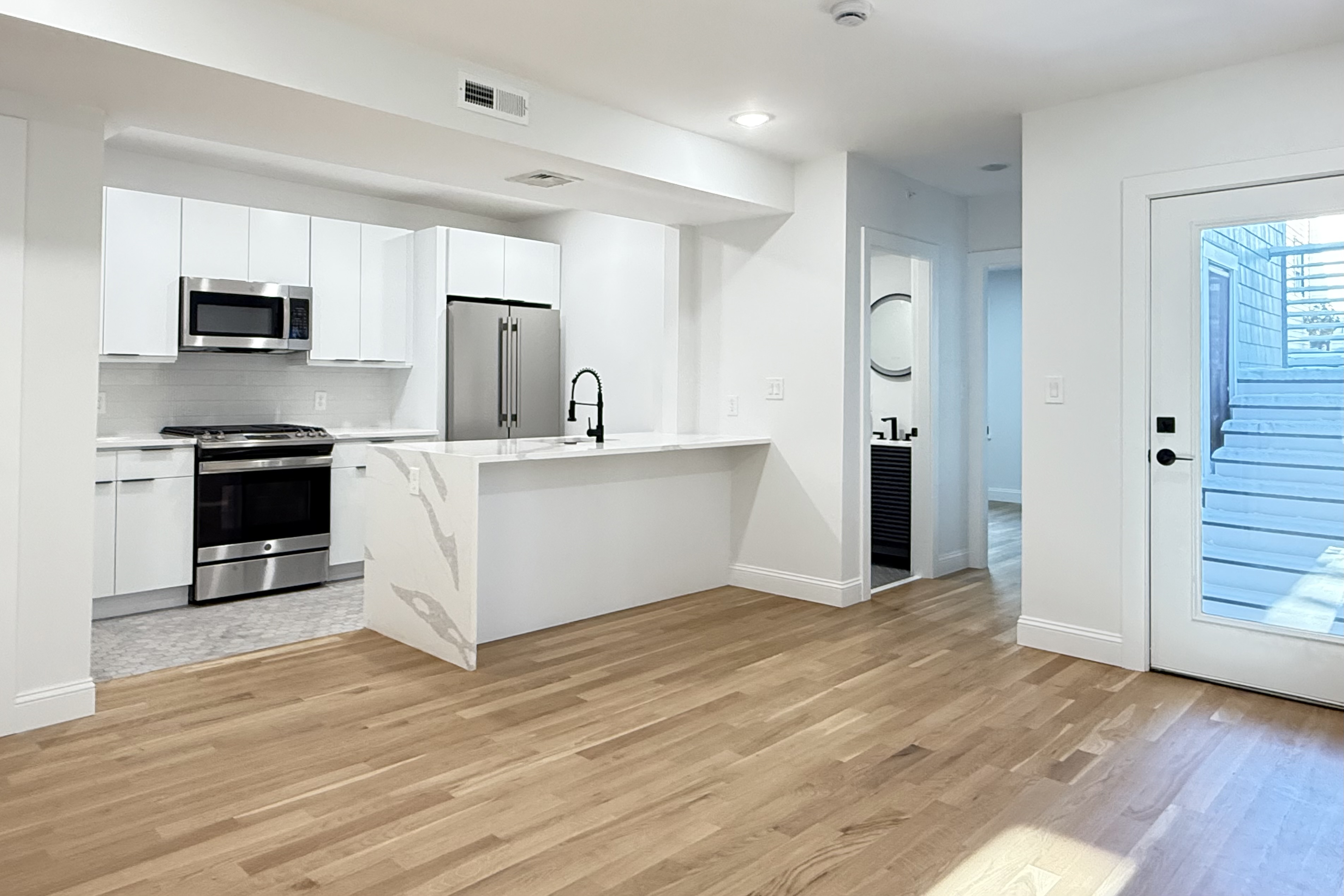 a kitchen with stainless steel appliances granite countertop a refrigerator and a stove top oven