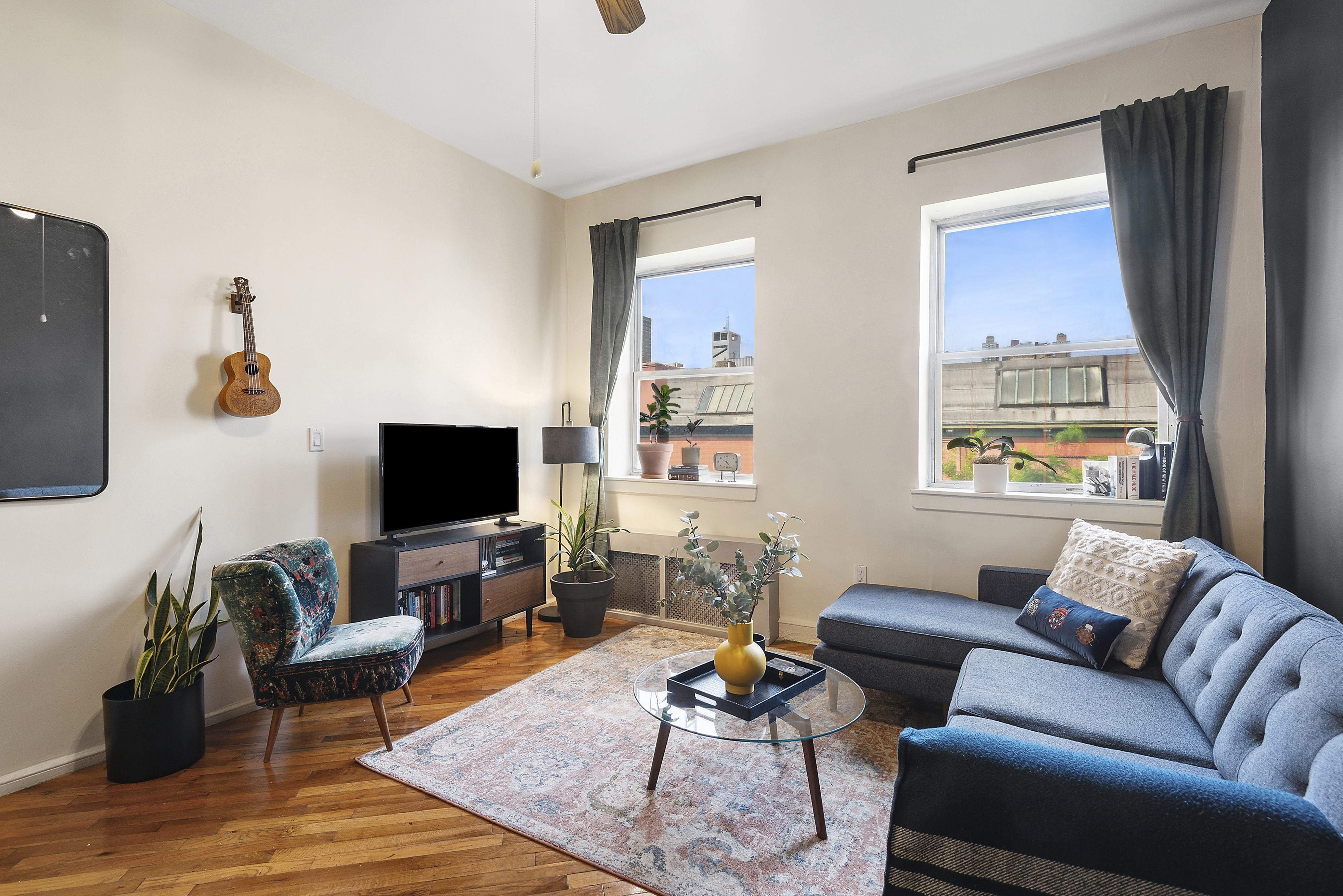 a living room with furniture and a flat screen tv