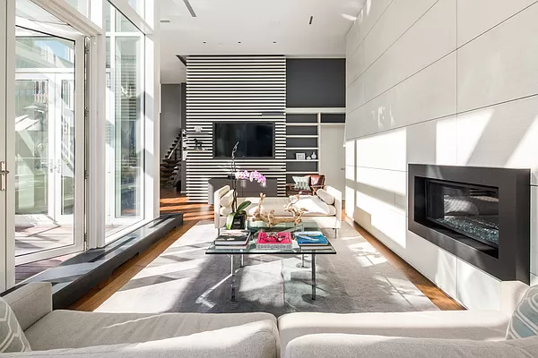 a living room with furniture flat screen tv and a fireplace