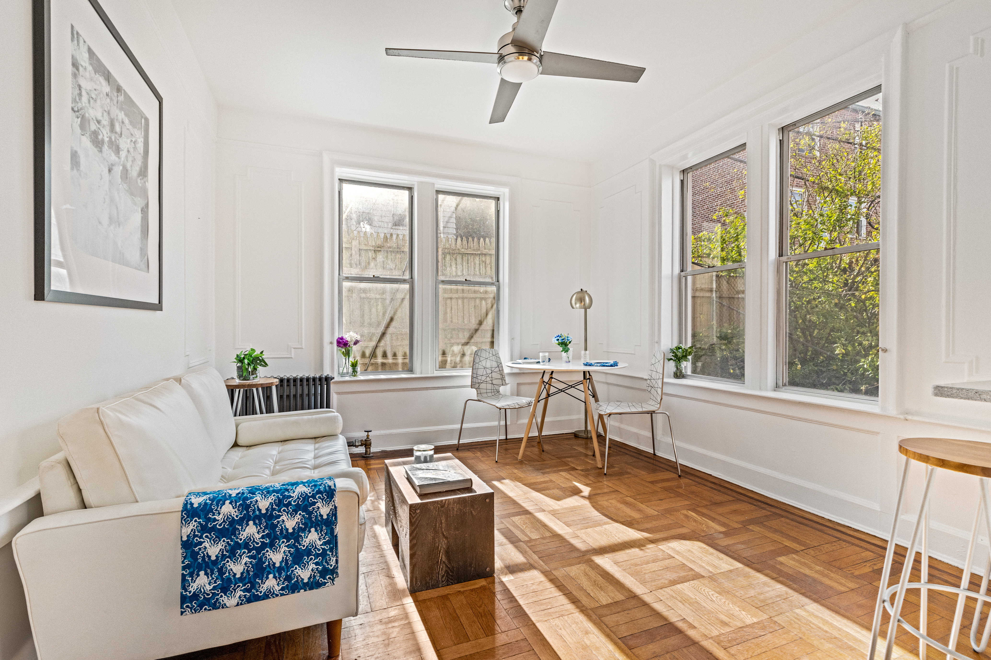 a living room with furniture large window and rug