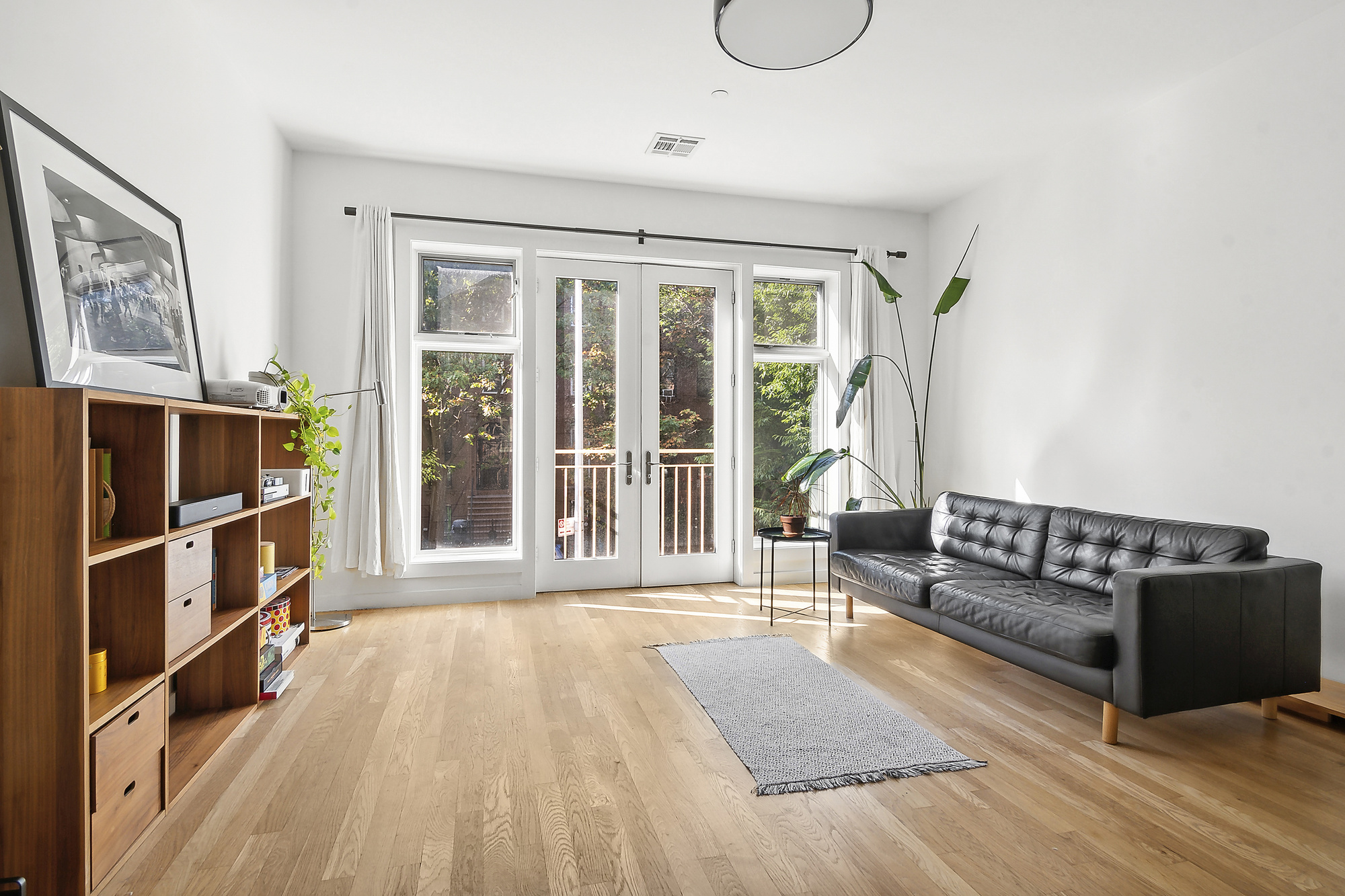 a living room with furniture and a floor to ceiling window