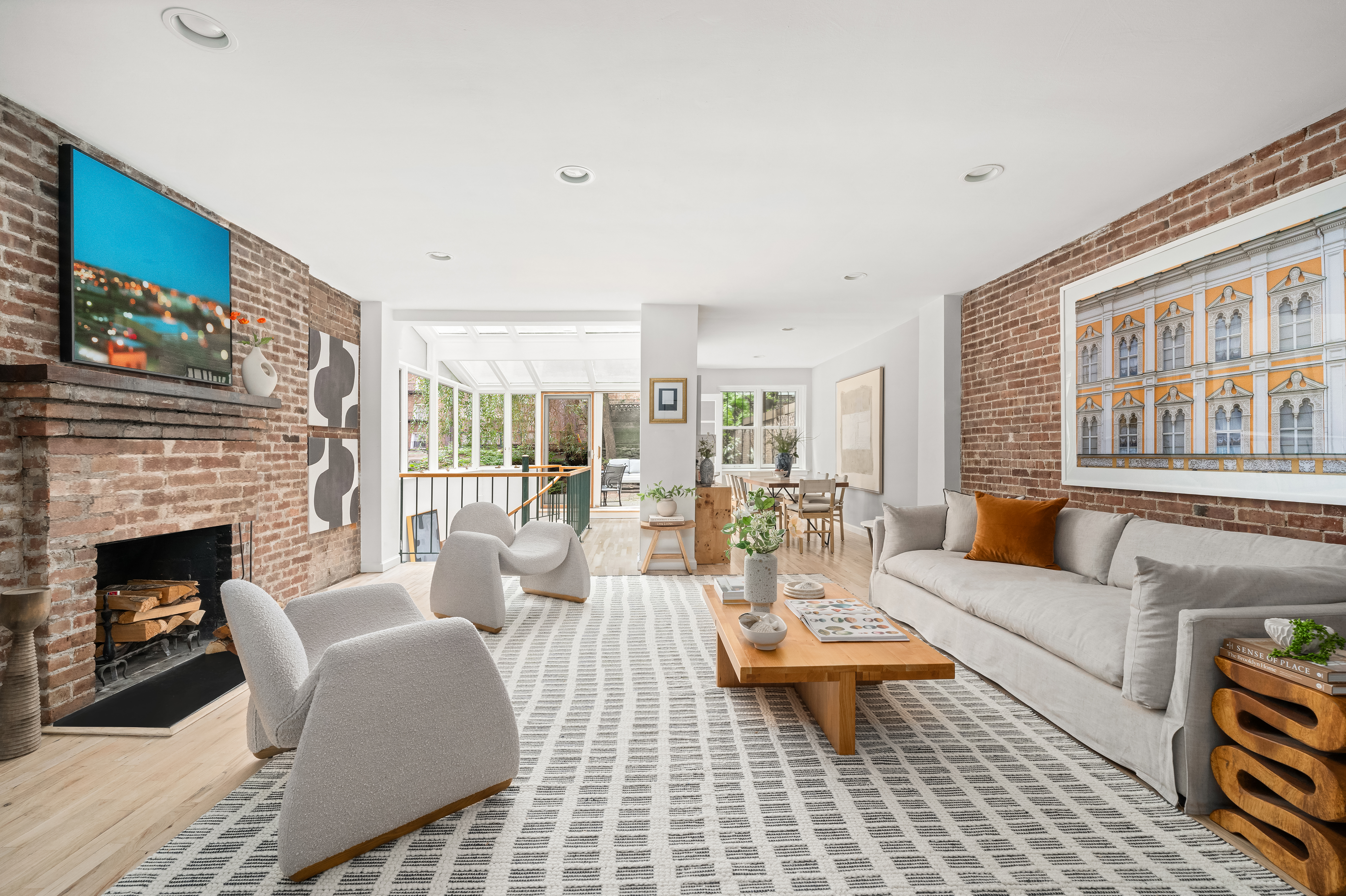 a living room with furniture a fireplace and a table