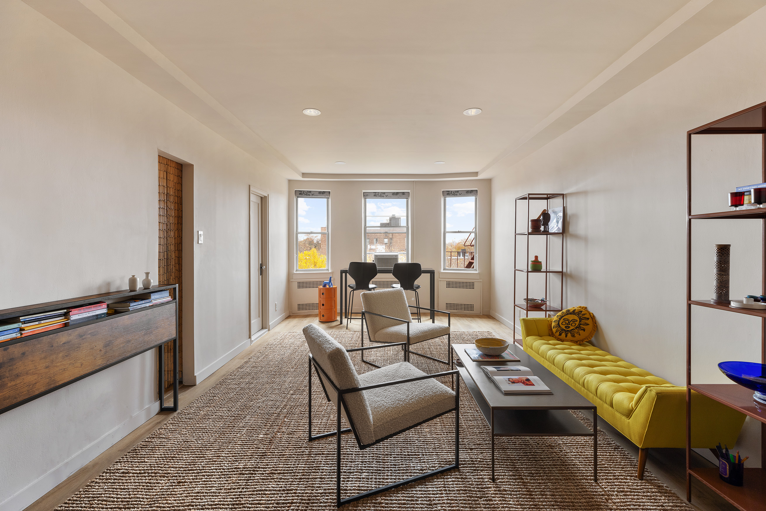 a living room with furniture fireplace and a window