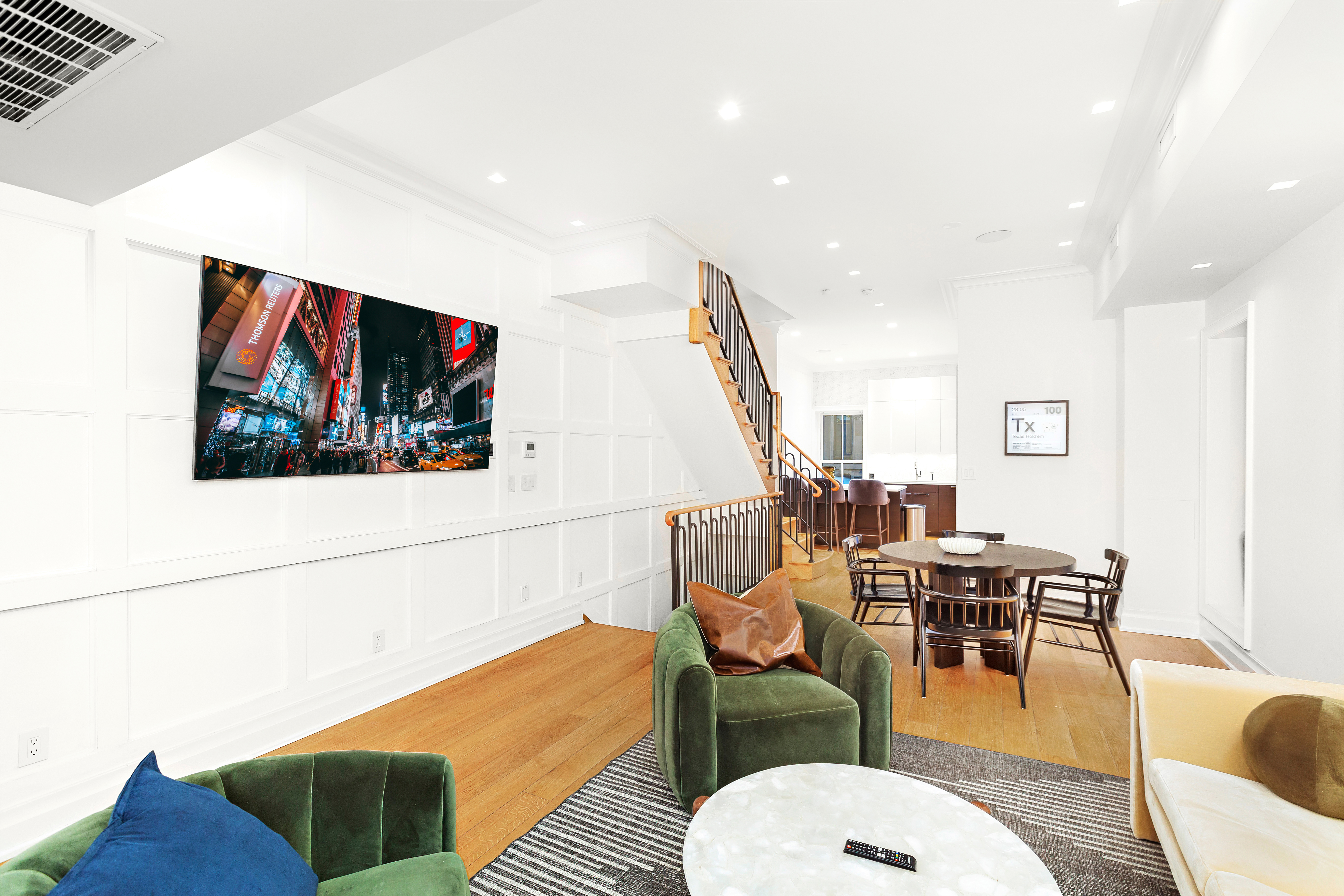 a living room with furniture kitchen view and a large window