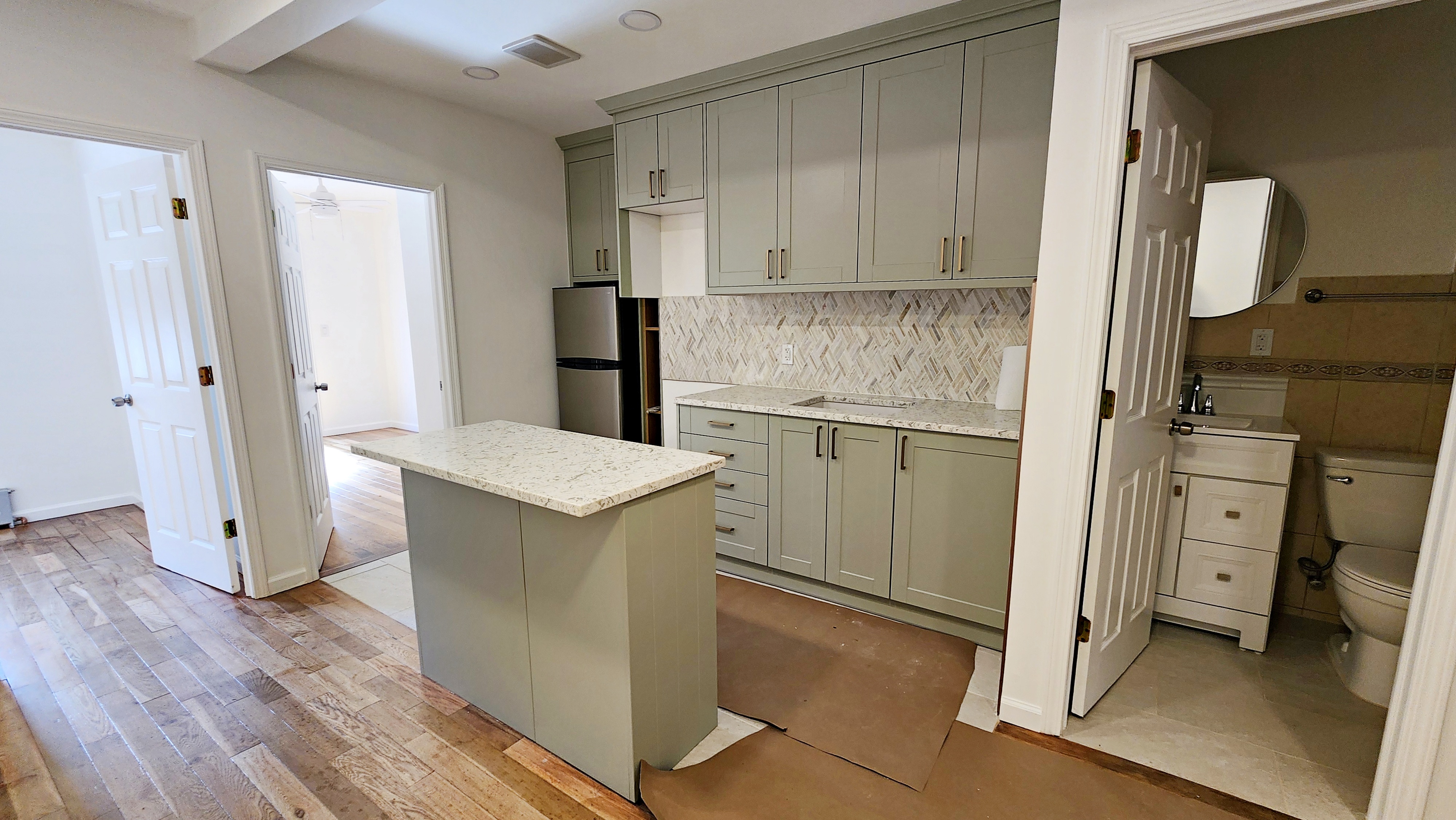 a kitchen with a refrigerator sink and cabinets