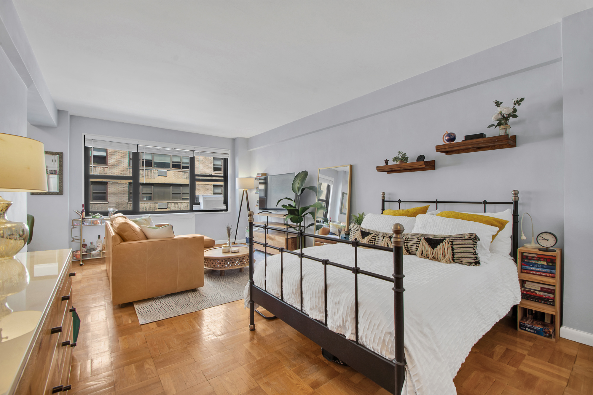 a bedroom with furniture and a wooden floor