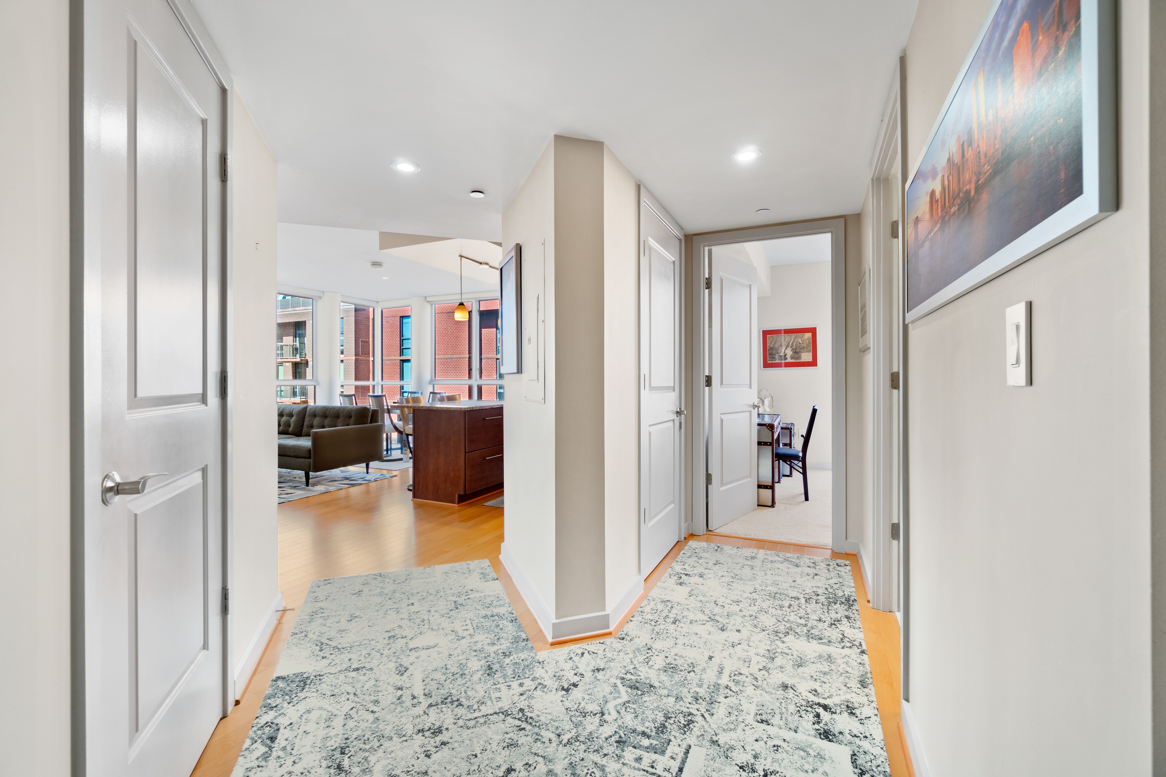 a view of a hallway with living room and dining room