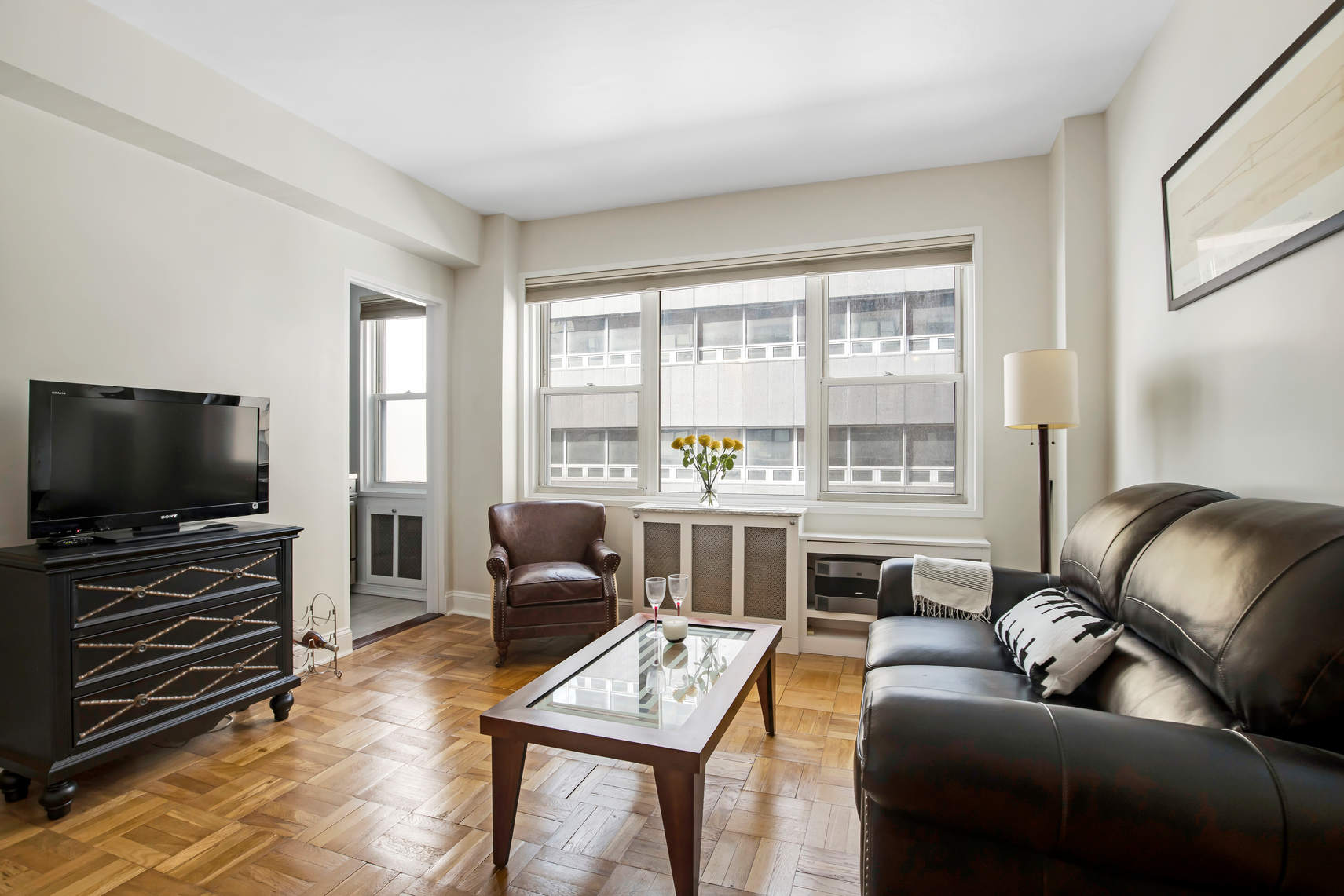 a living room with furniture and a flat screen tv