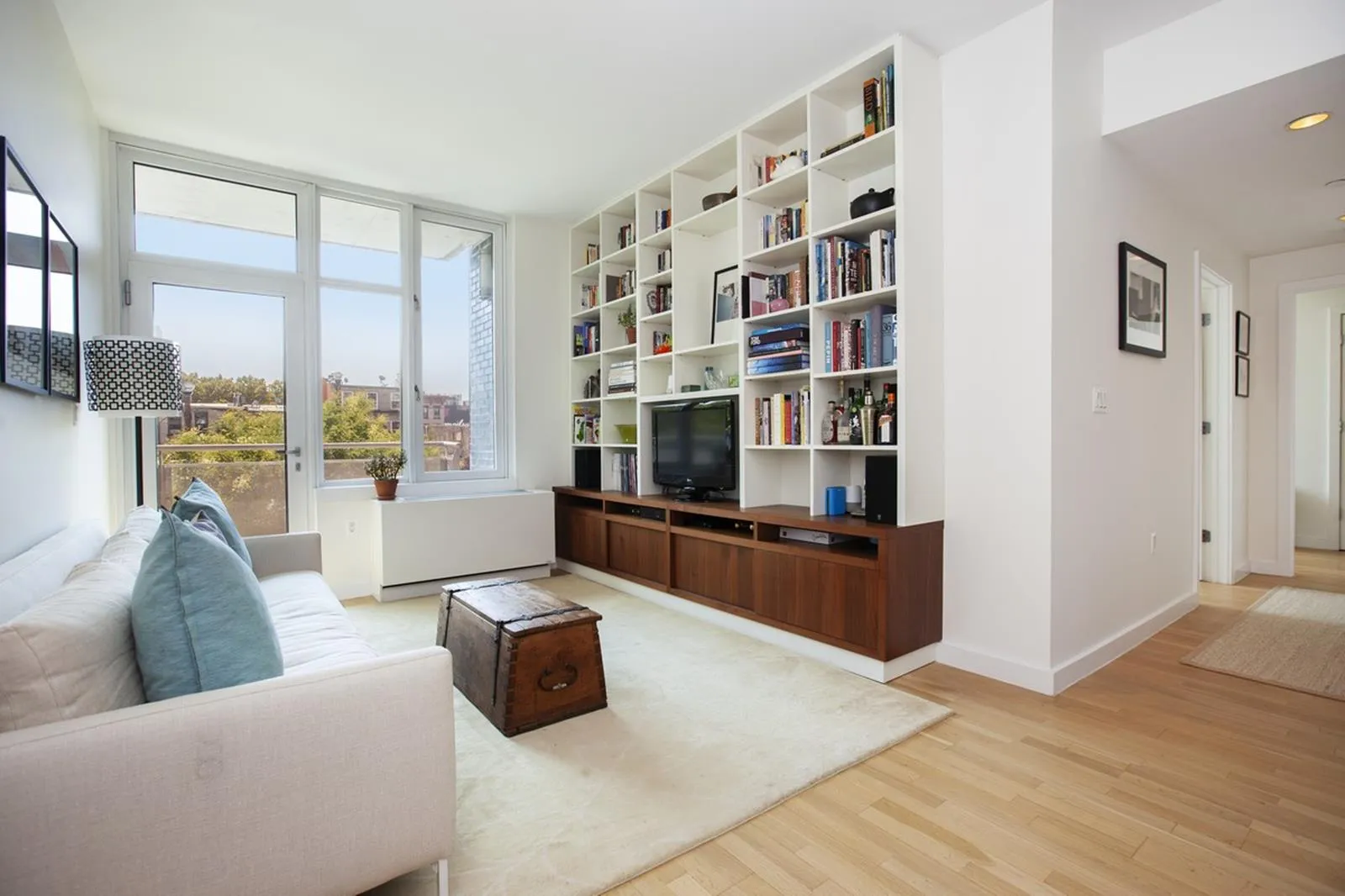 a living room with furniture and a large window