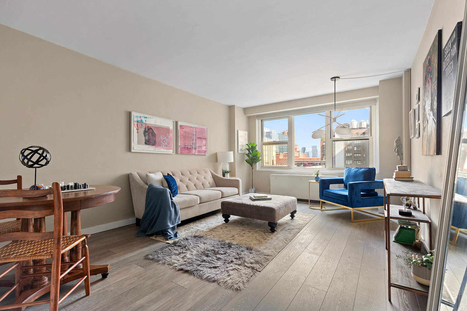 a living room with furniture and a wooden floor