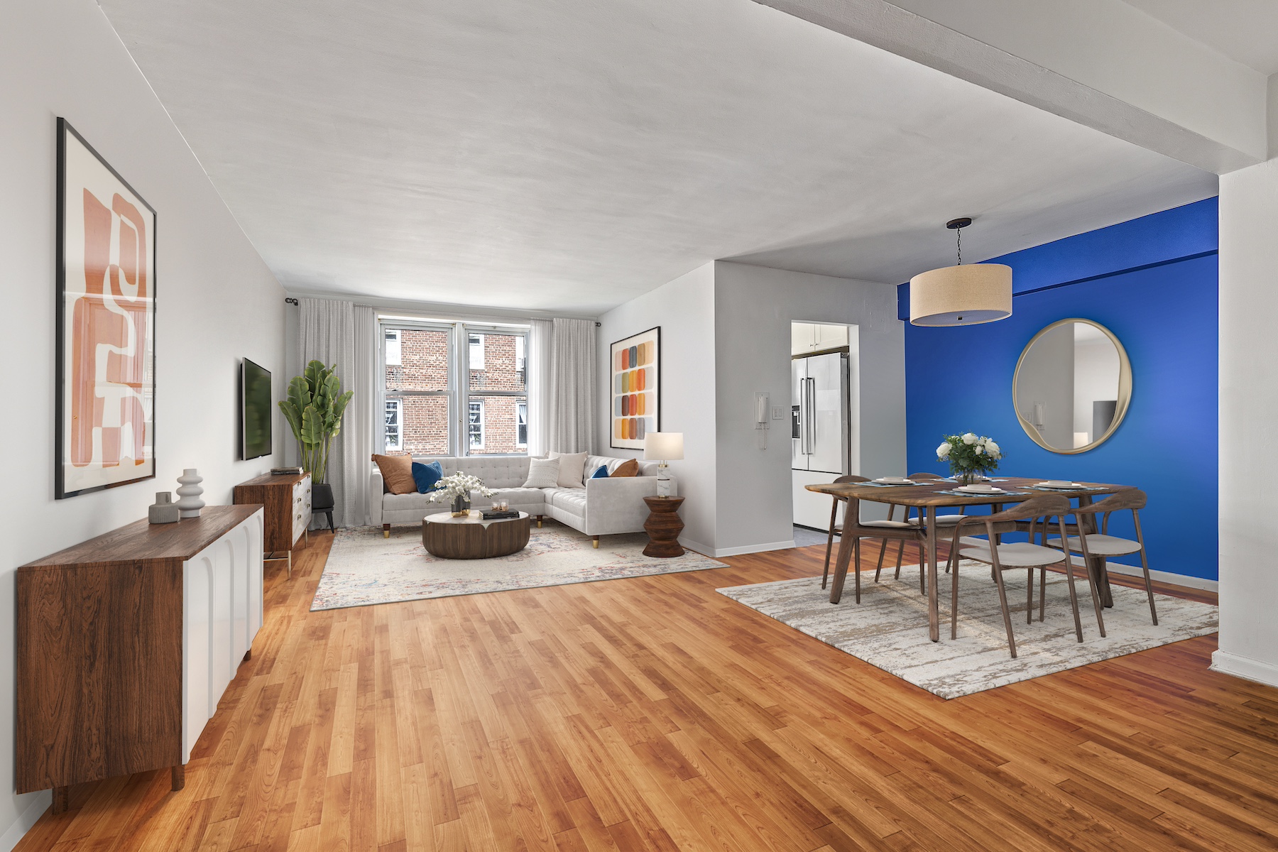 a living room with furniture a wooden floor and a large window