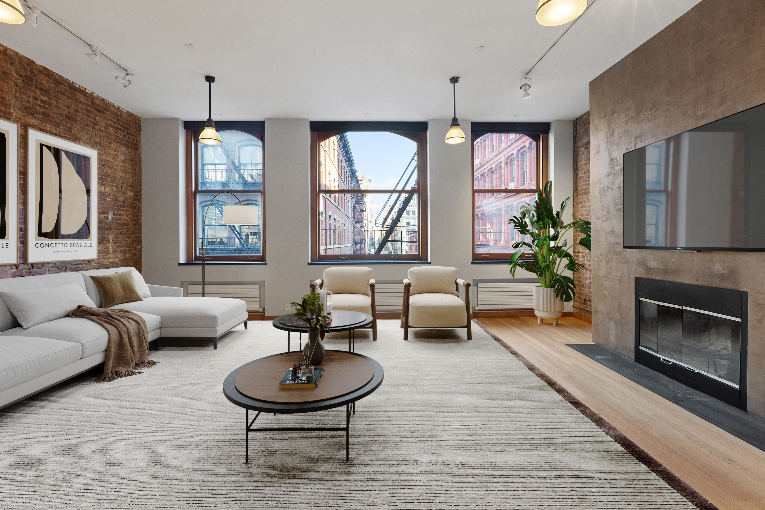 a living room with furniture a fireplace and a large window