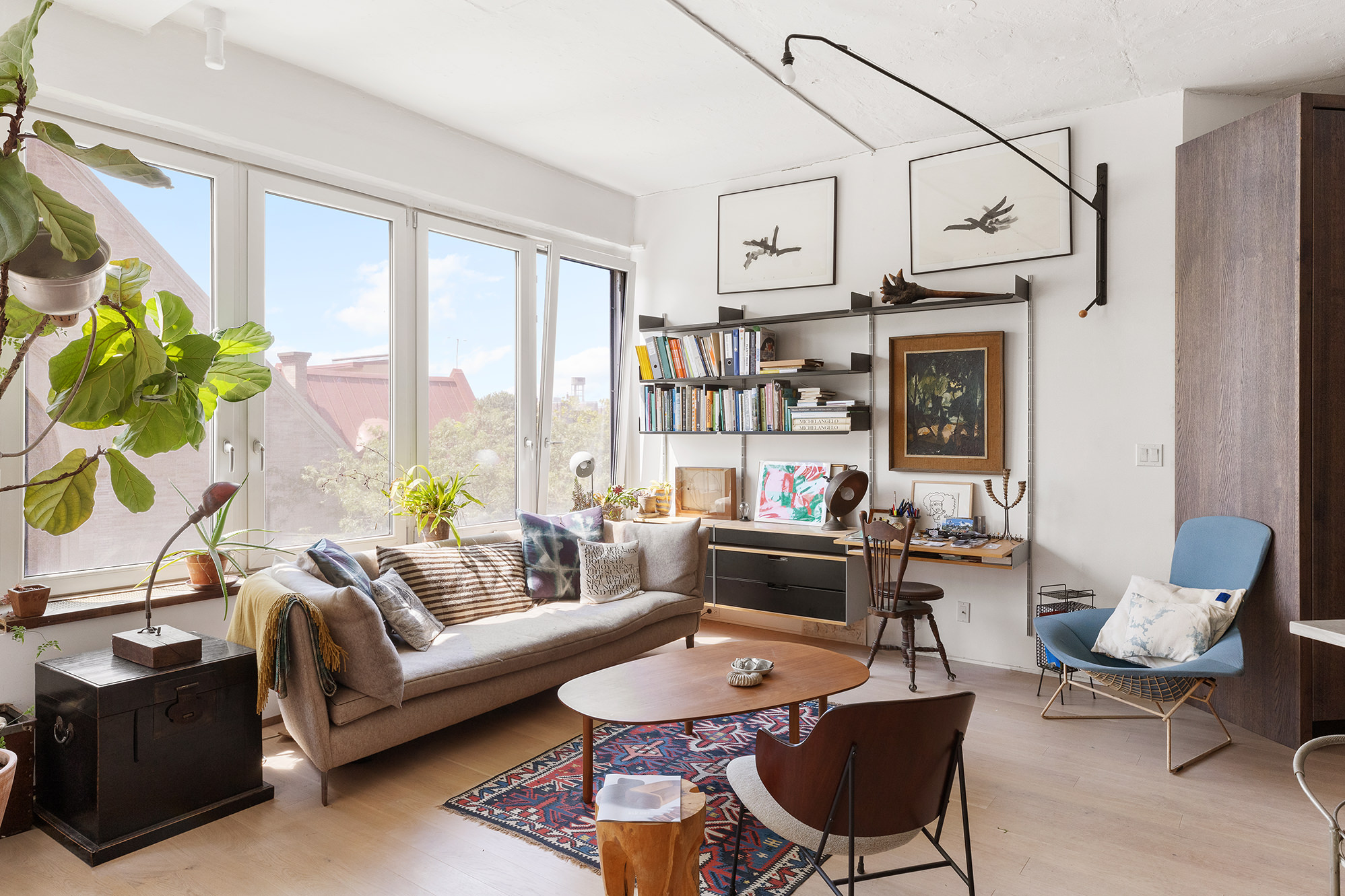 a living room with furniture a fireplace and a potted plant