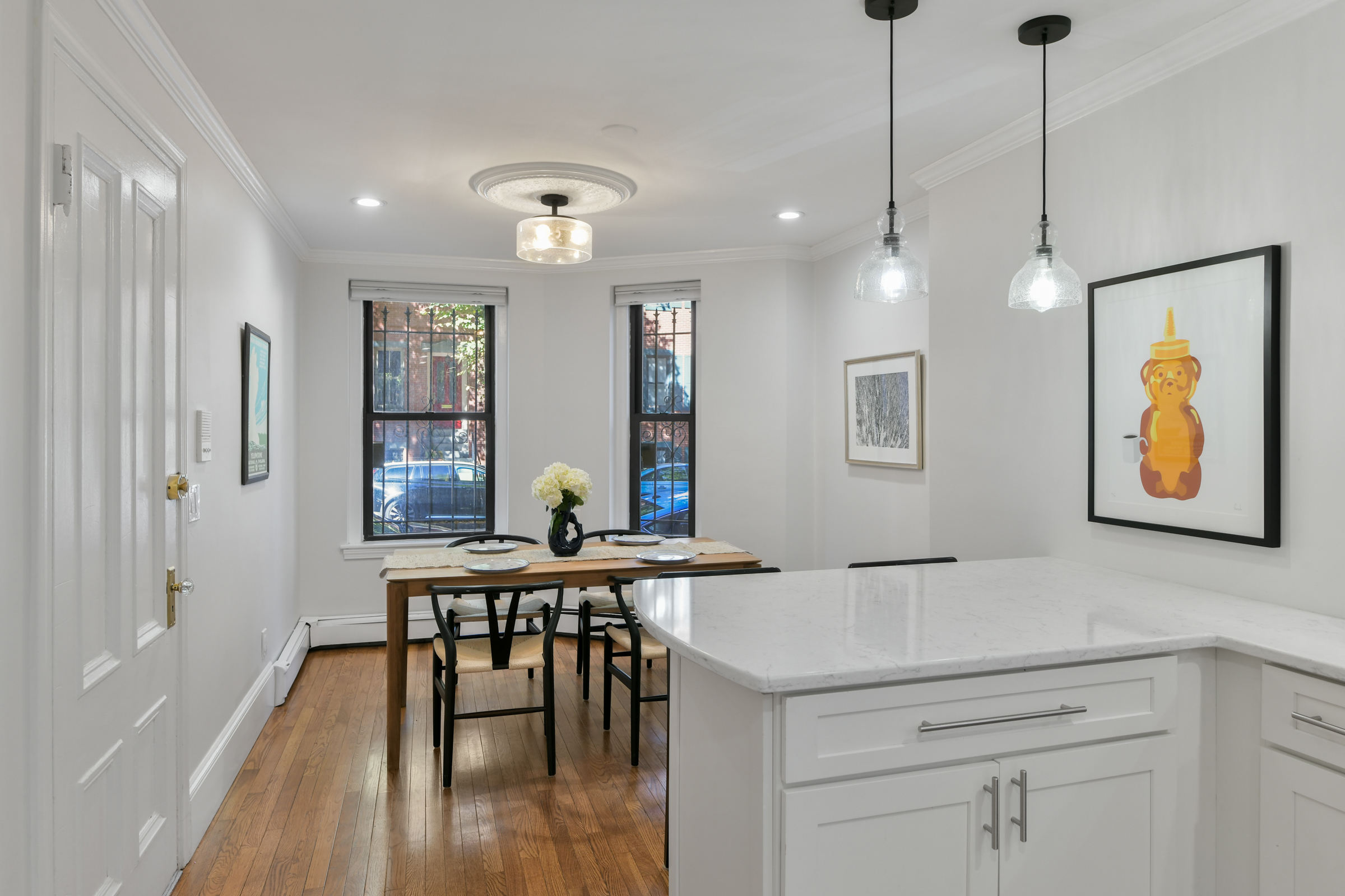 a view of a a dining room hardwood floor and a window