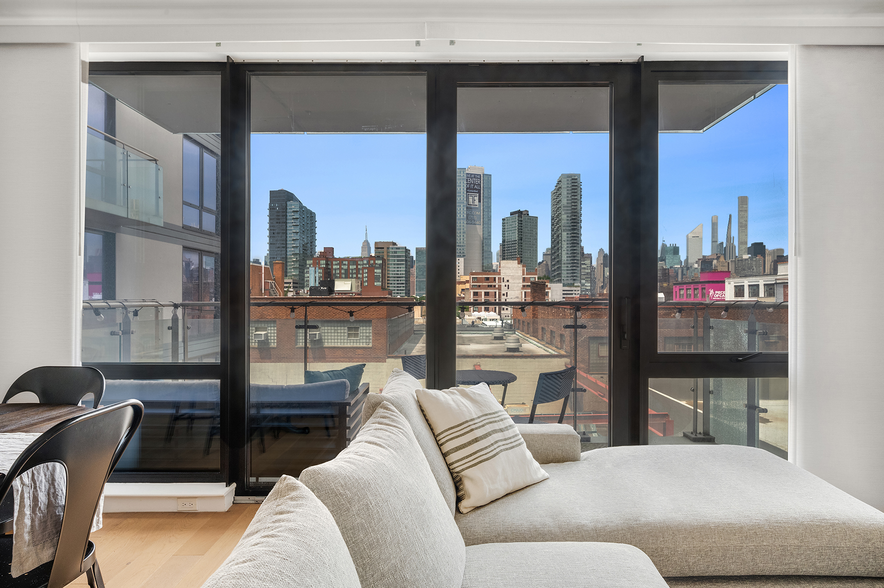 a living room with furniture and a floor to ceiling window