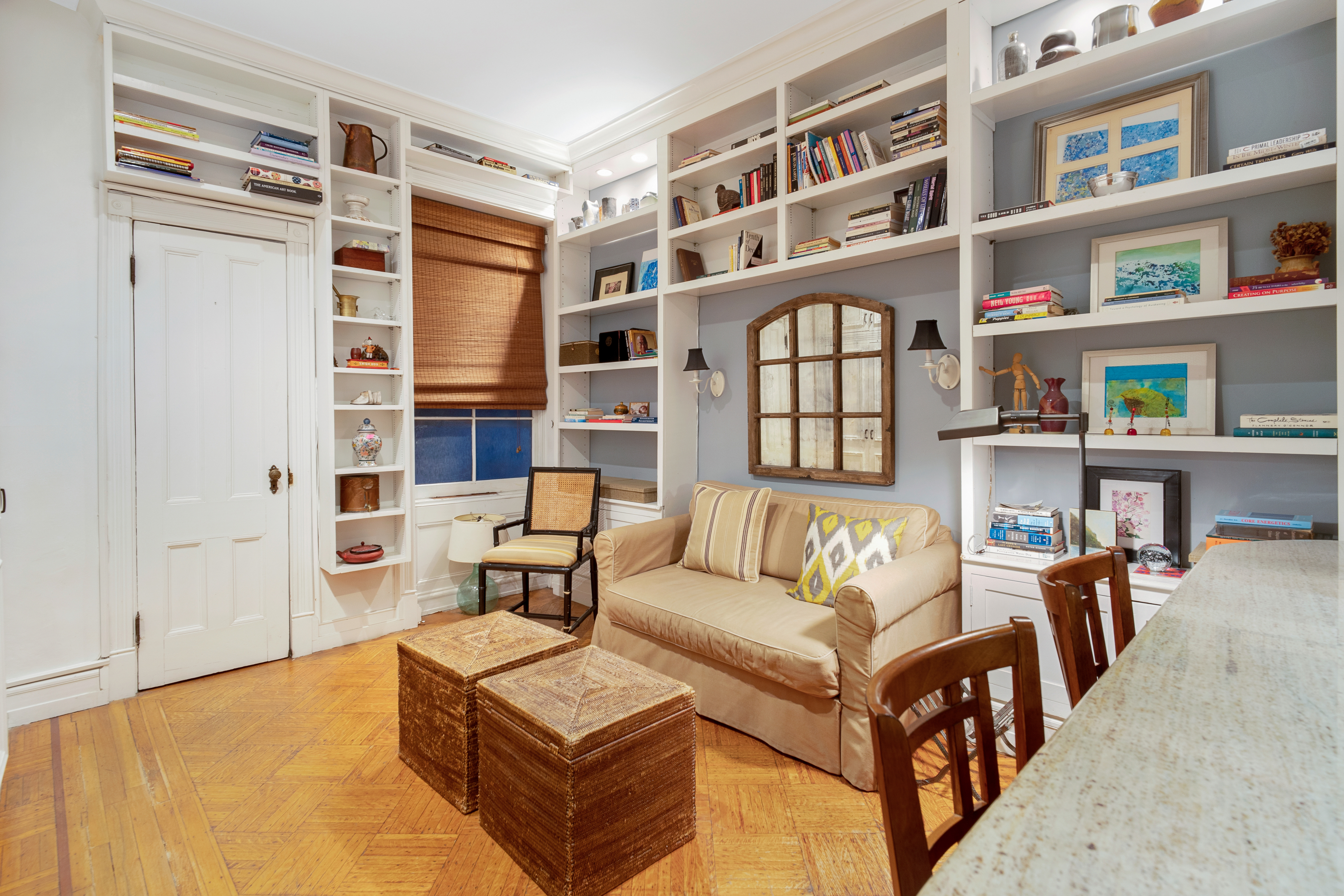 a living room with furniture and a book shelf