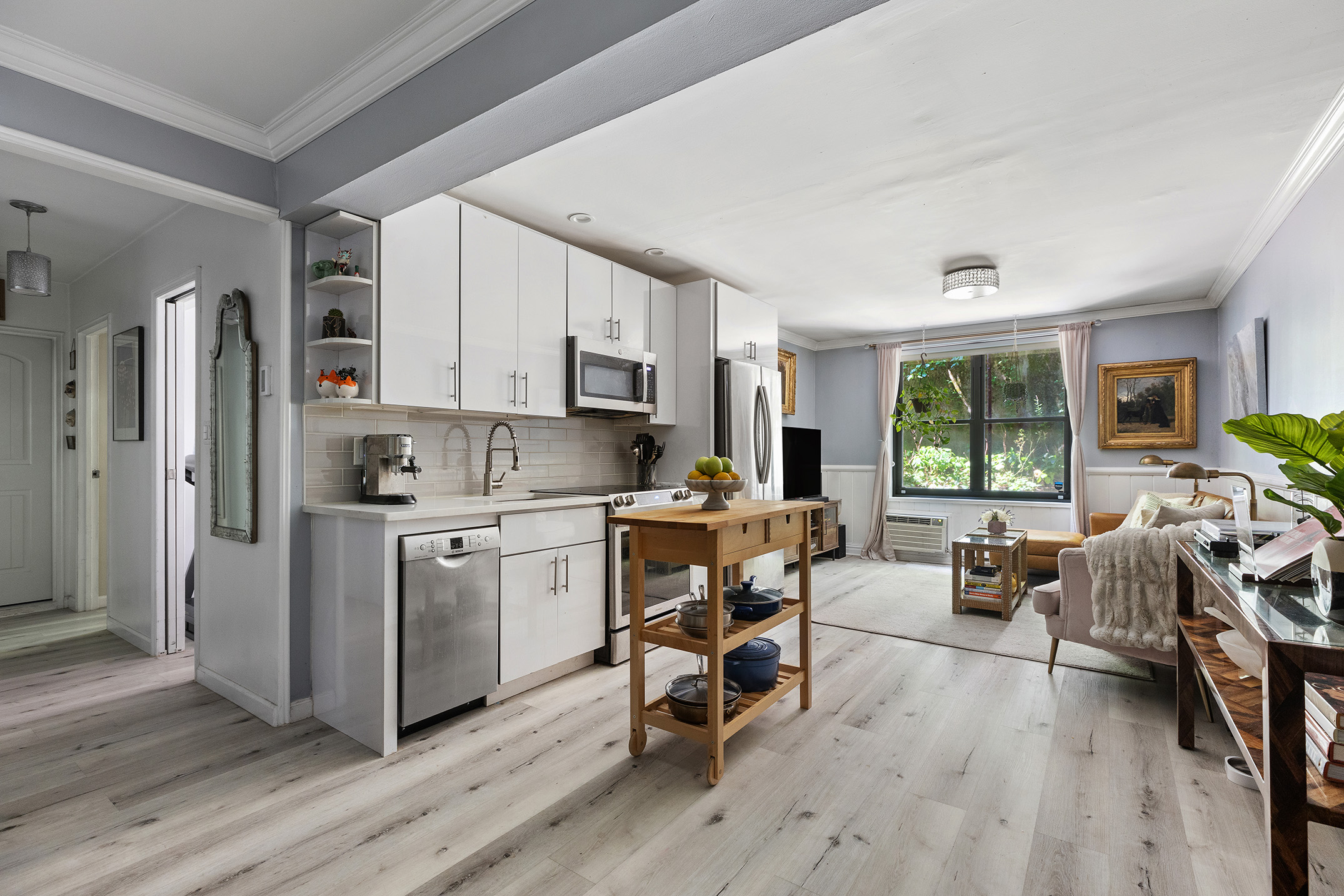 a kitchen with sink a refrigerator and wooden cabinets