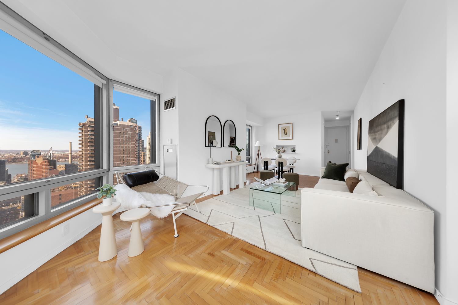 a living room with furniture a rug and white walls