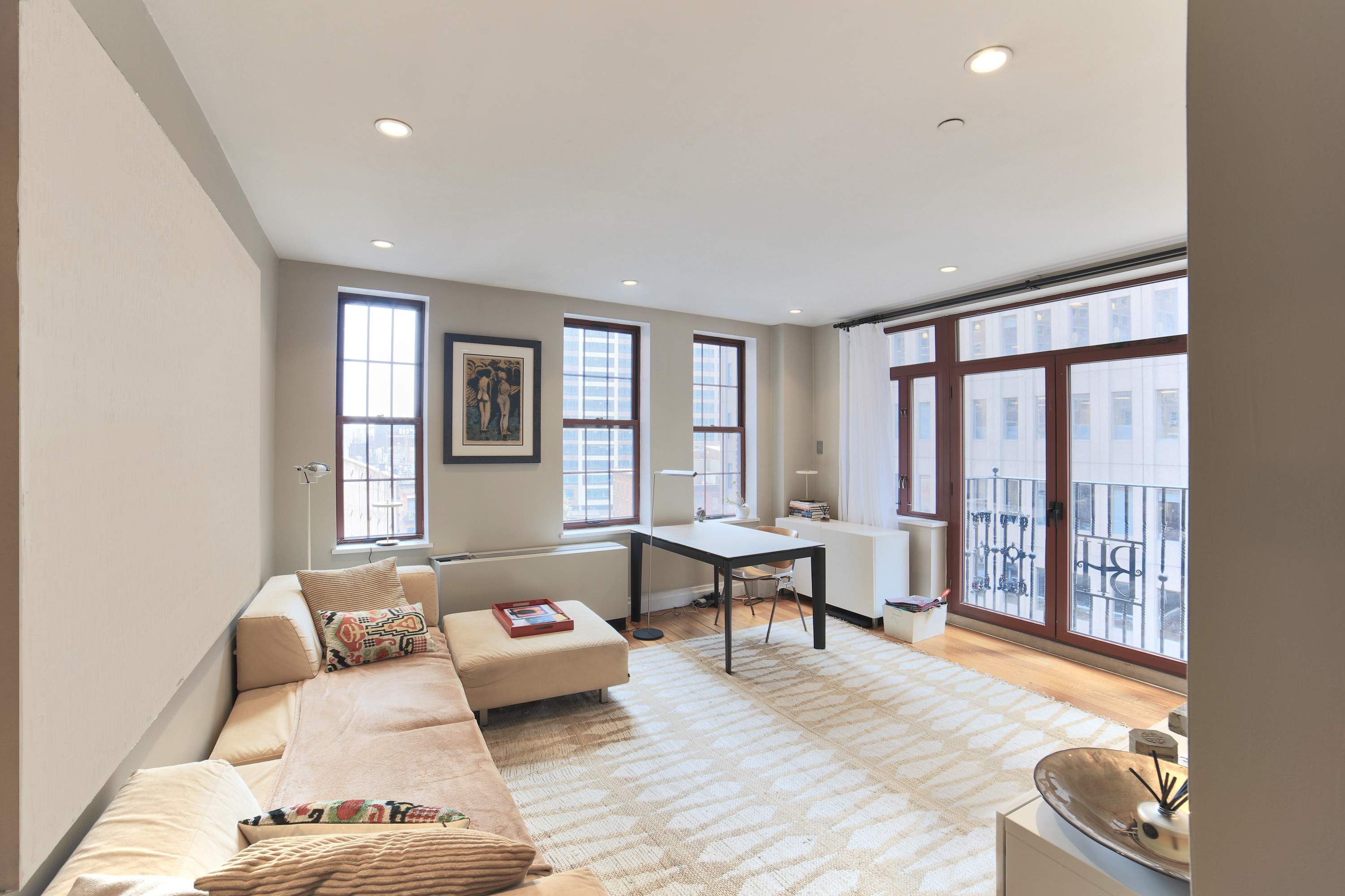 a living room with furniture and large windows