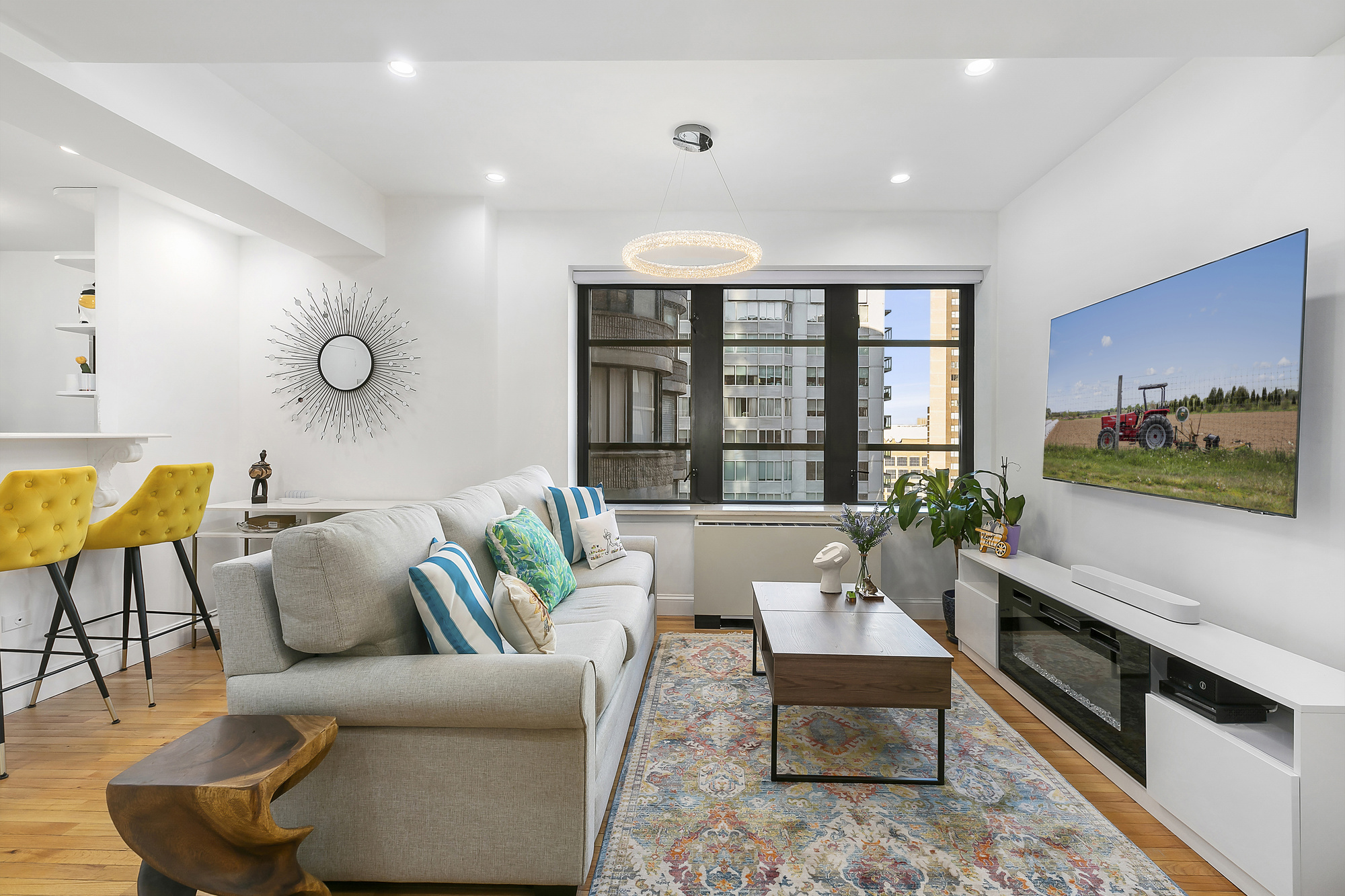 a living room with furniture and wooden floor