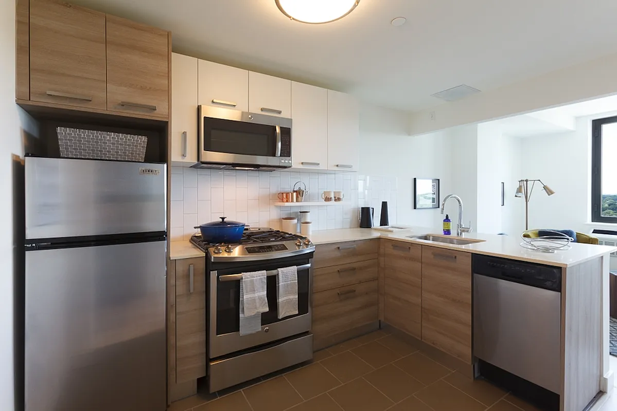 a kitchen with stainless steel appliances a refrigerator stove and microwave