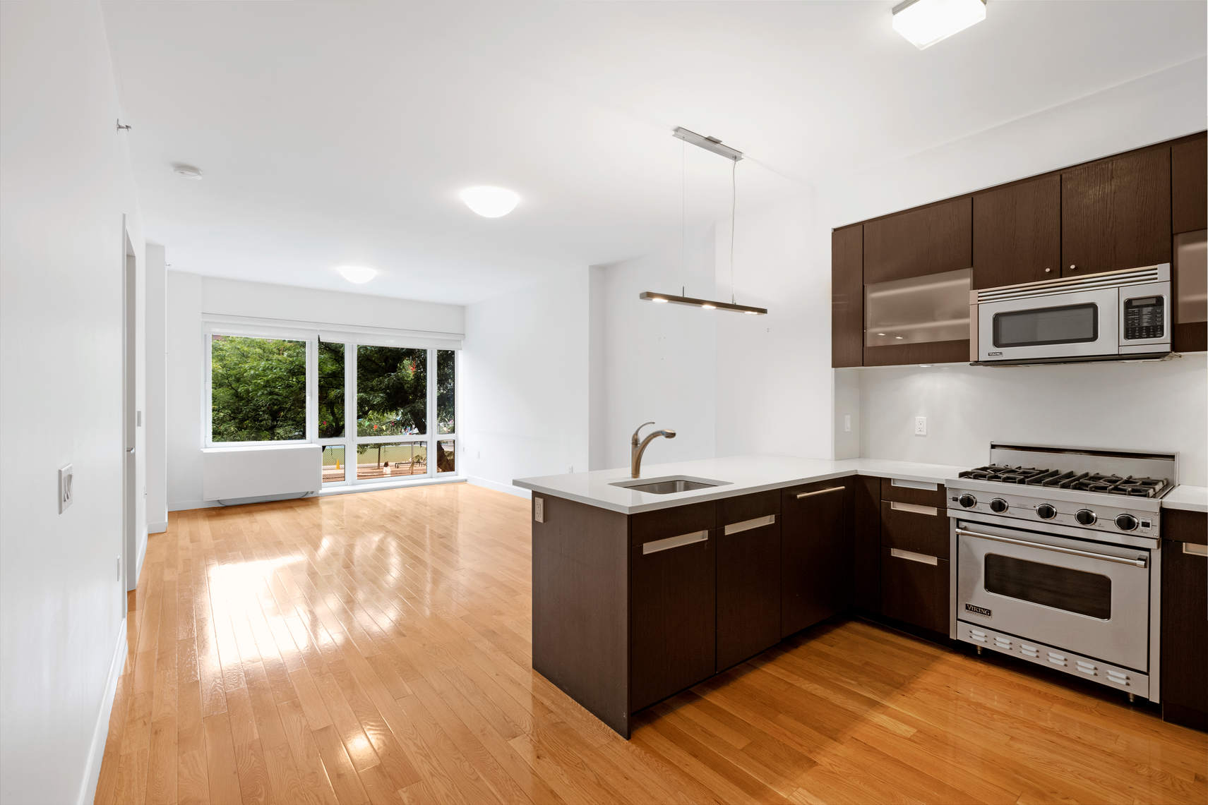 a kitchen with stainless steel appliances a stove sink and microwave