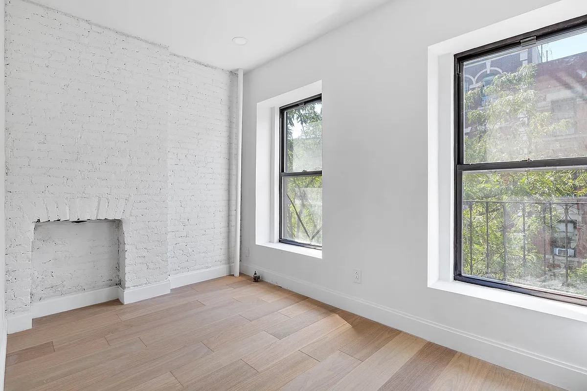 an empty room with windows and closet