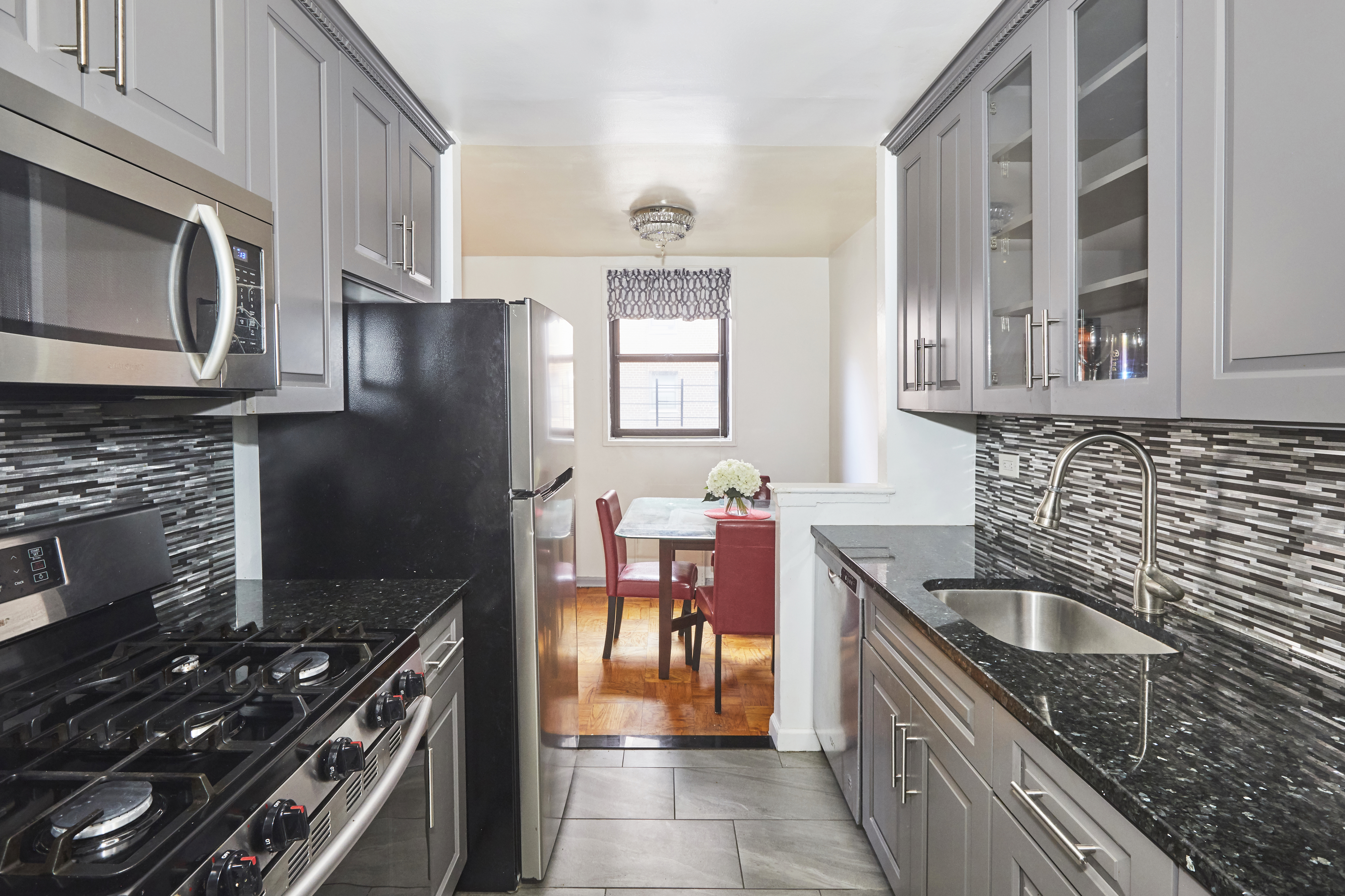 a kitchen with stainless steel appliances granite countertop a sink stove and refrigerator